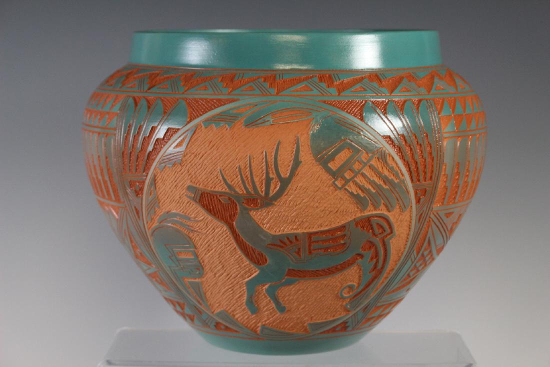 Large Southwest Native Acoma Pottery: Redware, with cut back painted turquoise with deer. Pueblo hopi vessel, signed on bottom "Laguna Acoma" dated 1993 and others. Measuring approx. 9" h x 11"w. Condition is good see photos. Native Ameri