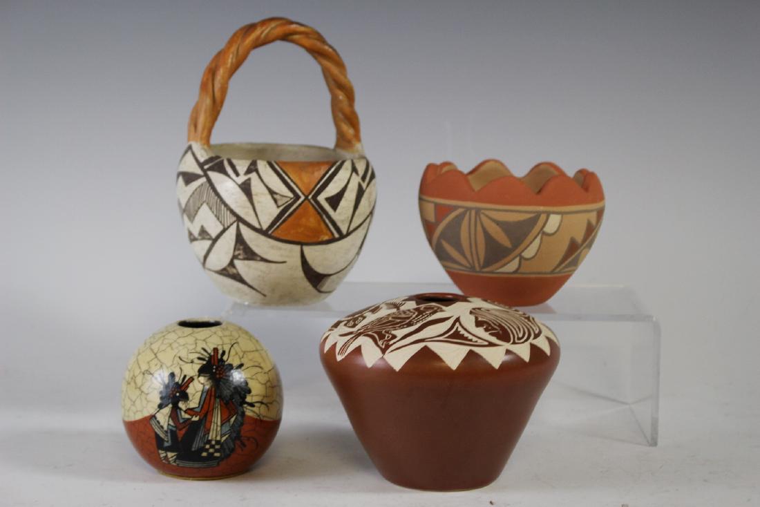 Group of Southwest or Indian Pottery: Including Juanita Jemez New Mexico bowl, Pauli signed limited edition 81/125 1988 vase, Talking earth 1-272animals and faces etched back bowl and a Acoma N.M. Navajo Pueblo pottery basket 7" tall. All