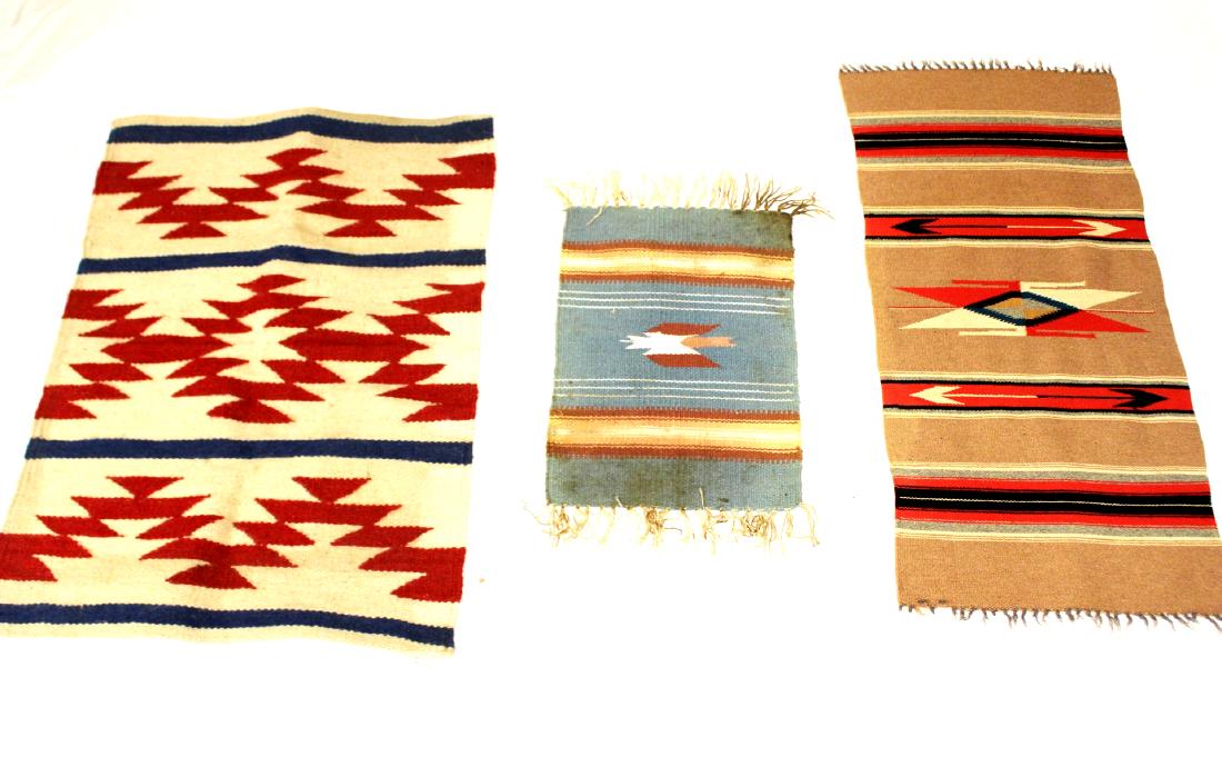 Three (3) Indian Rugs: Three small Indian throws or rugs, including one red white blue rug approx. 37" x 27", one 40" x 18" southwest American Indian throw and one small 24" x 14" with many stains and soiling as shown.