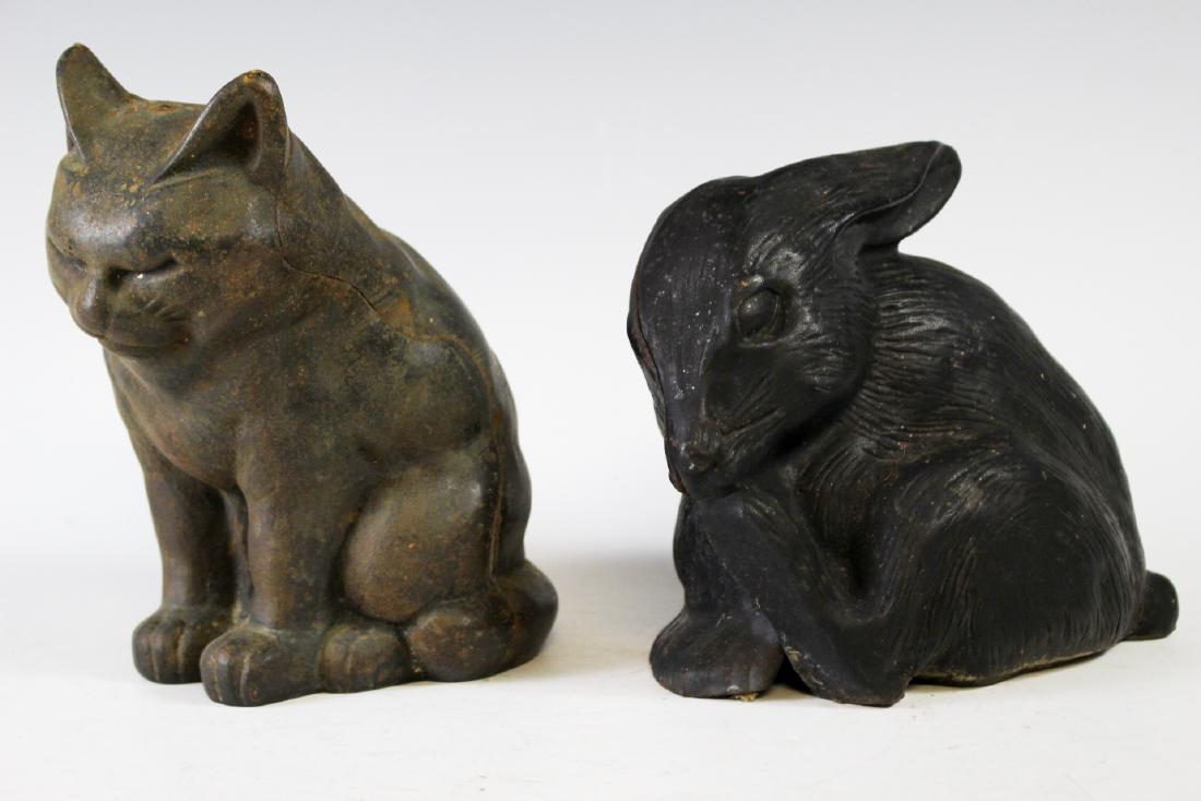 Two Cast Iron Animal Doorstops: Including a rabbit and cat, measuring approx. 6" and 8" tall. Signs of use and age as shown.