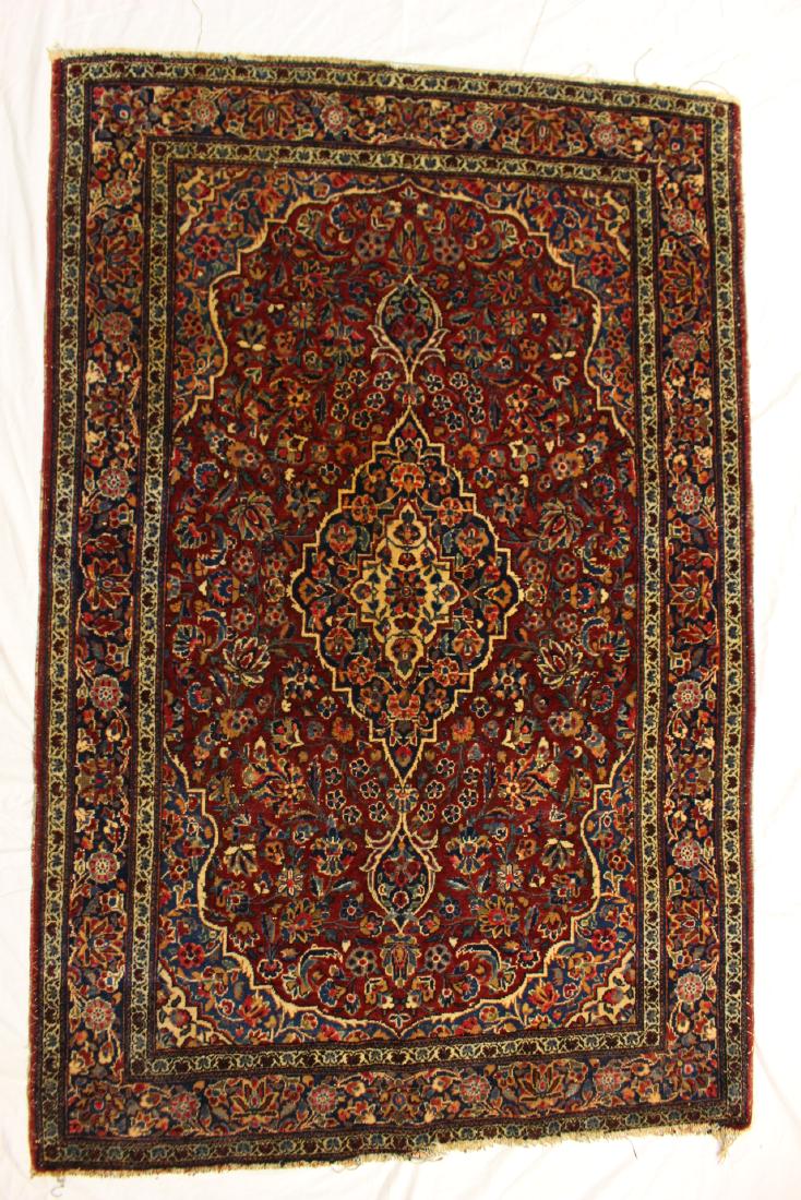 Persian Sarouk Carpet: Double bordered center medallion Sarouk. Approx. 61" by 41". Having original tag on verso. Light fringe loss and edge wear otherwise good condition, see photos.
