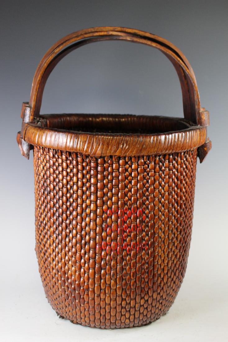 Signed Chinese Woven Basket: Signed on handles near both sides in black ebonized writing, bent wood handles and dated. Measuring approx. 24" tall x 16" dia. Very good condition with some dust soil consentient with age as shown, s