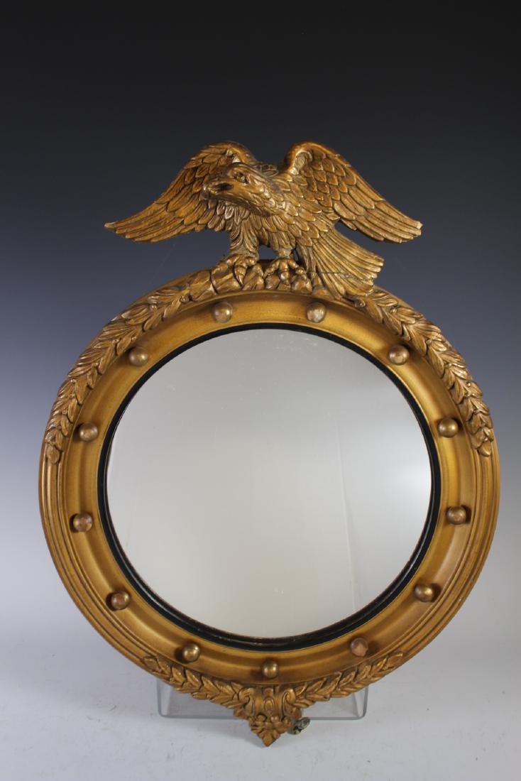 Federal Style Bullseye Mirror: Early 20th century gesso Federal style wall mirror having open winged eagle crest. Some light loss to gild, see photos. Approx. 25" t by 19" w.