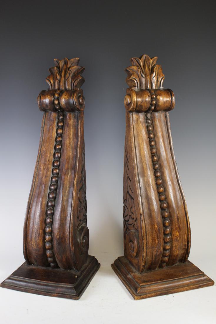Carved Architectural Corbels: Carved pair of softwood 20th century corbels with walnut stain. Measuring approx. 24" tall. Condition is good with modern mounting brackets in place. See photos.