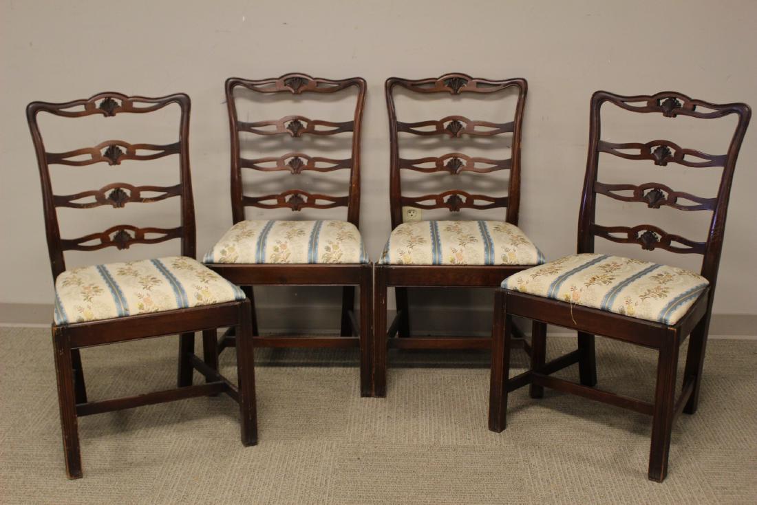 Set of Four Chippendale Chairs: Set of four mahogany Chippendale style dining room chairs having slatted shell carved backs. Some scuffs and nicks throughout and dust soil. See photos. Measuring 38" H x 19" W x 18"D.