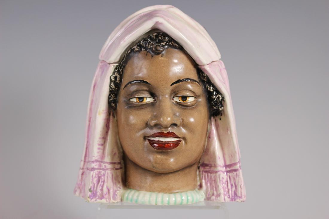 Middle Eastern Arabic Woman Tobacco Jar: Porcelain head with polychrome pigments in gloss and matte, impressed 4369. Wonderful color and expression. Condition: Small flakes at bottom of base. Measuring approx. 6" tall.