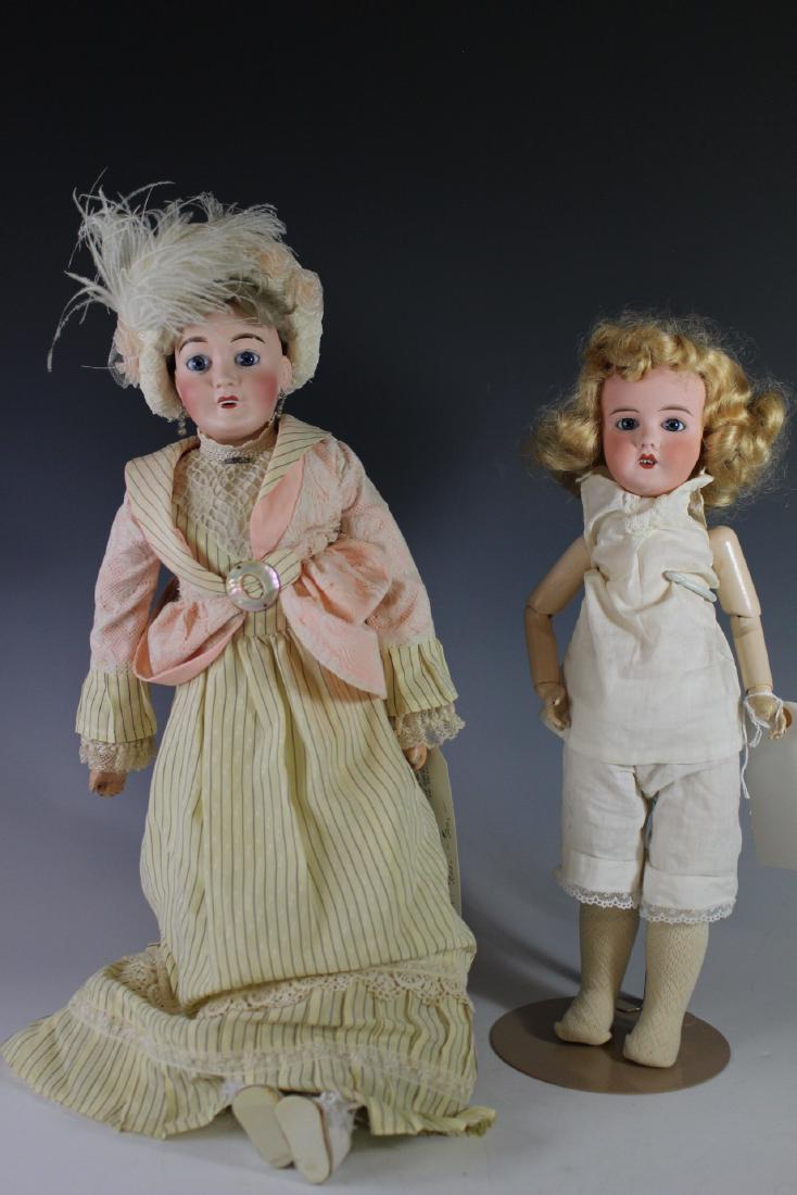 Two Antique French Lanternier Limoges Dolls: Ca. 1900-1910 "Al& Cie Limoges Ed Tasson" on kid body, open mouth, original Mohair wig with painted bisque arms. Set eyes square cut teeth, on bisque shoulder plate "Depose Fabrication Francaise Favor