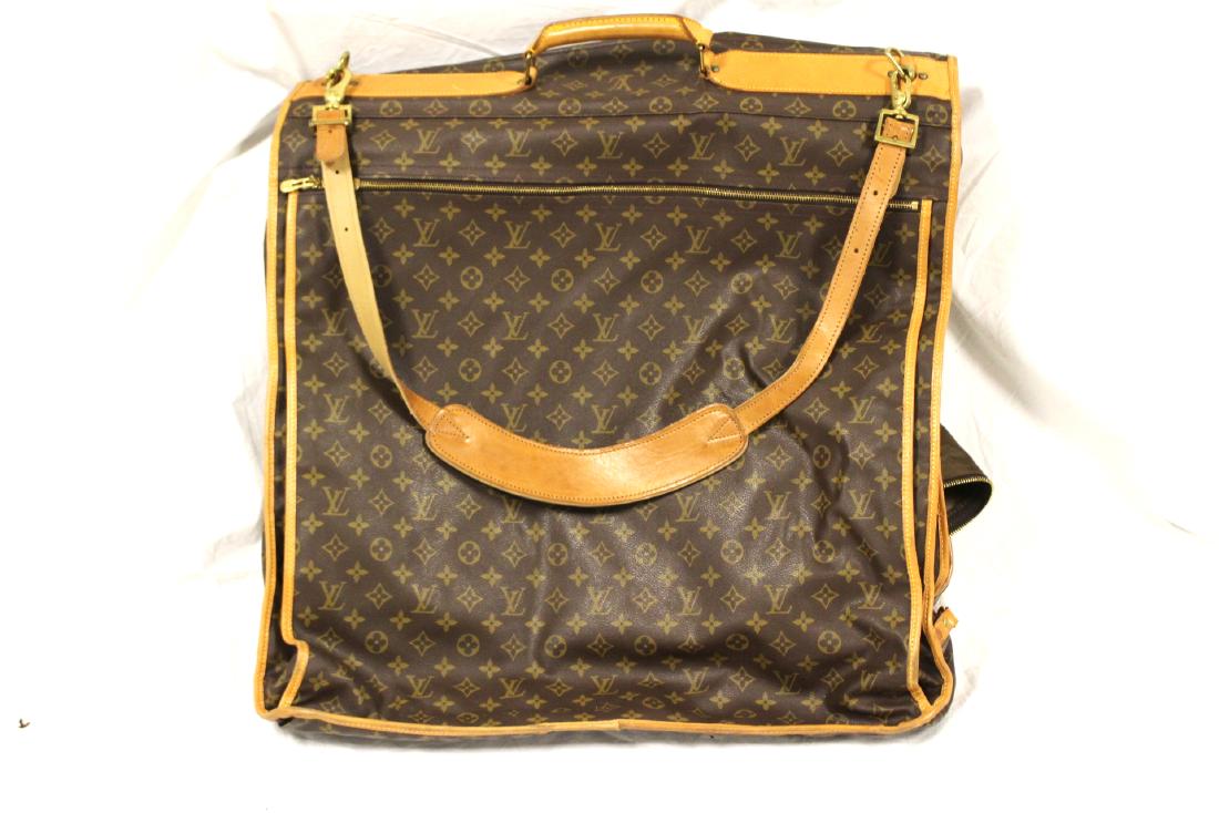 LOUIS VUITTON MONOGRAM CANVAS GARMENT BAG: LOUIS VUITTON MONOGRAM CANVAS GARMENT BAG, 23" X 18" (CLOSED): Measures 23" x 39" open. Leather is stamped "(R enclosed within a circle) Louis Vuitton Malletier"; hardware is also stamped. Minimal wea