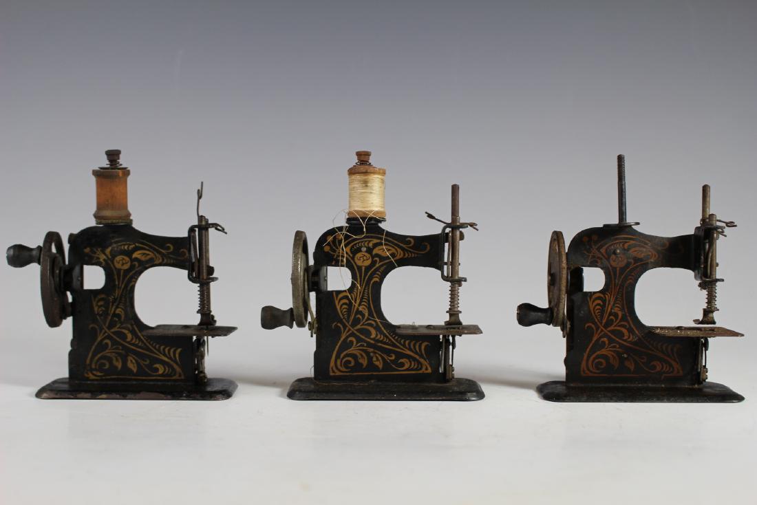 Three Small Tin Litho Miniature Sewing Machines: Three Small Tin Litho Miniature Sewing Machines. Hand crank sewing machines in working condition. Some losses to finished areas as shown, metal pitting see photos. Approx 5" x 4".