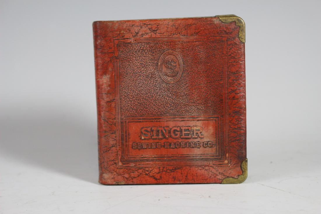 Singer Advertising Still Bank: VERY NICE OLD ADVERTISING BANK SINGER SEWING MACHINE CO. - metal with leather or faux wrap embossed with advertising as shown. No key present, some oxidation to metal. See photos.