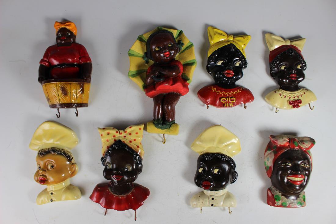 Black Americana Collectibles: Including pot hook holders and decorative wall items. Condition is fair to good with some losses and paint touch up.