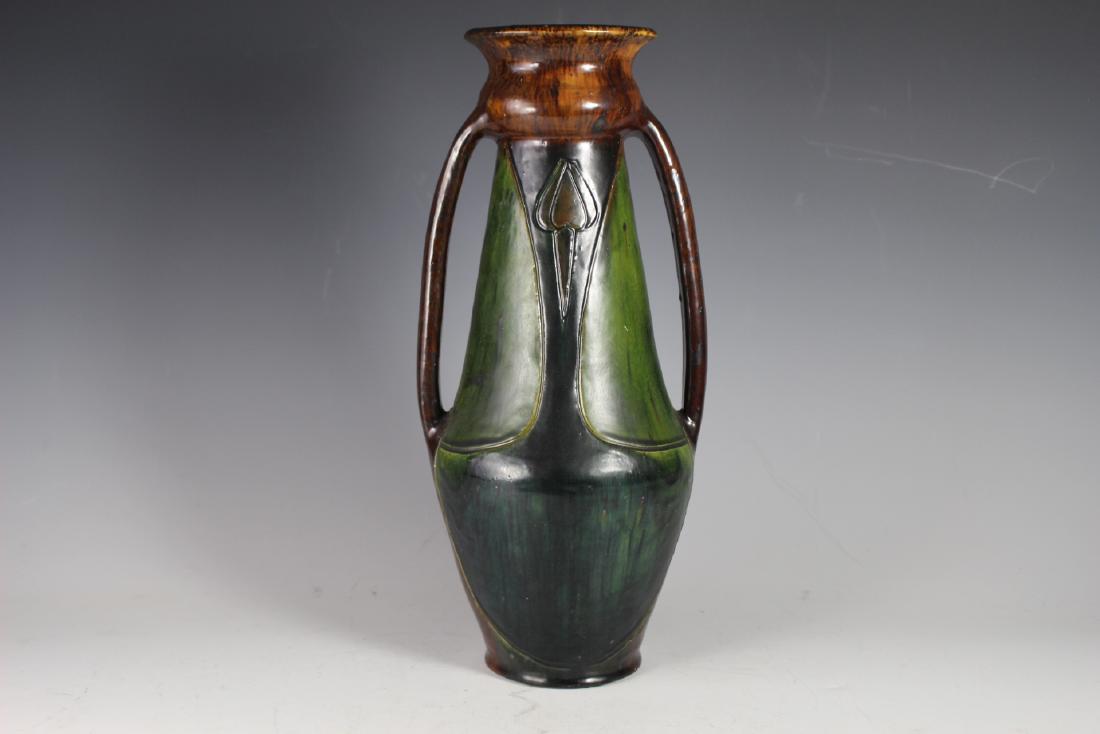 Arts and Crafts Vase: Doubled handled Stickley or roycroft influenced through the arts and crafts movement. No found stamps or signatures. Having tulip decoration on the neck of the vassal as shown. Rim chip on verso and o