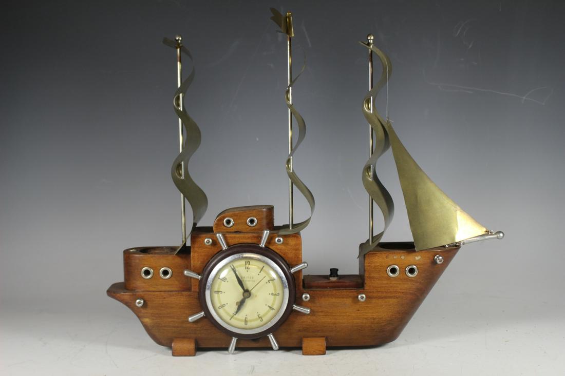 United Electric Self Starting Ship Clock: United Electric Self Starting Ship Clock: Wood and chrome novelty sailing ship with ships wheel dial, 5 chrome sails and 2 magnifying lights and red and green starboard and port lights. 16" Tall x 20"