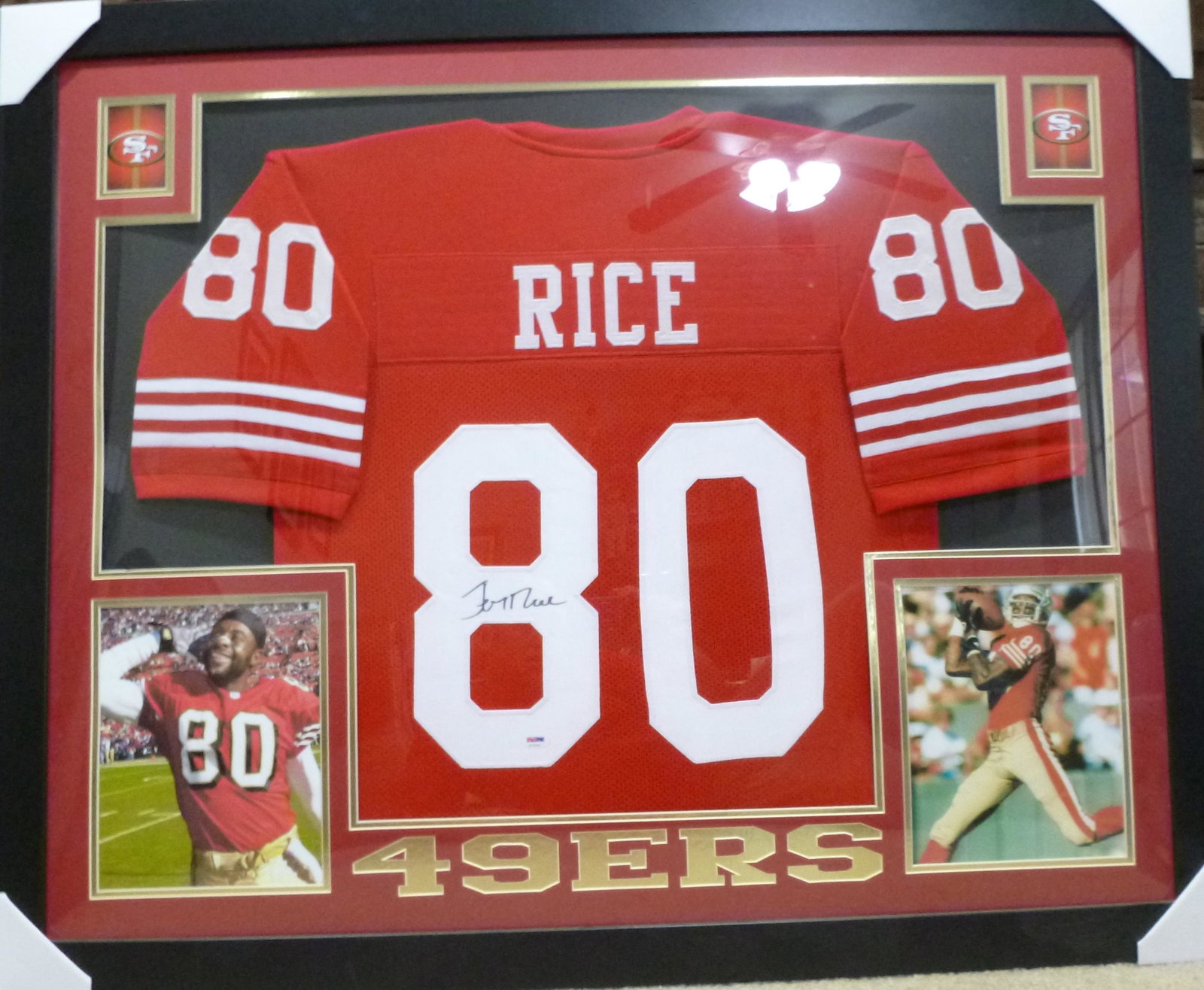 Jerry Rice Framed and Matted Signed 49ers Jersey: Just shy of 36" x 44" display that includes a signed jersey and matted photos, team name and team logos. Plexiglass front. Ready to hang up and enjoy. PSA/DNA certified Oversized item for shipping.