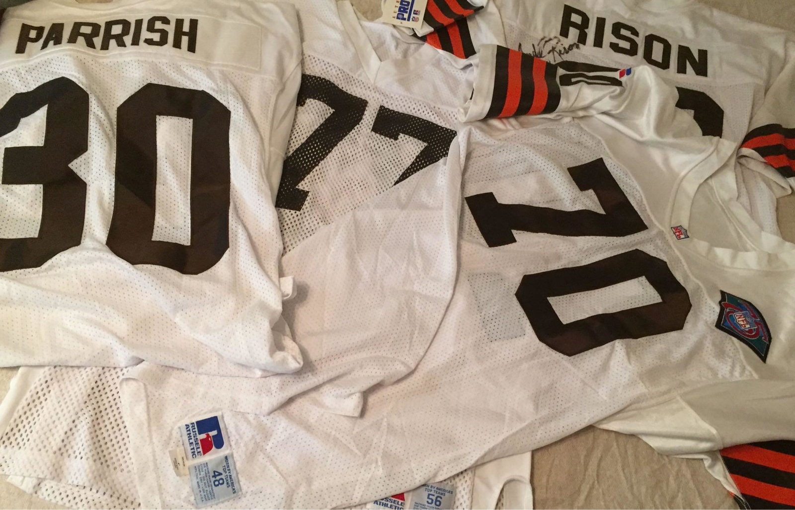 Cleveland Browns 1990's Jersey Collection: Four different white Browns jerseys. One is an Andre Rison store model jersey that was signed by hum. One is a size 56 Russell Athletic practice jersey, 77 numbers. Other two must have been team issue