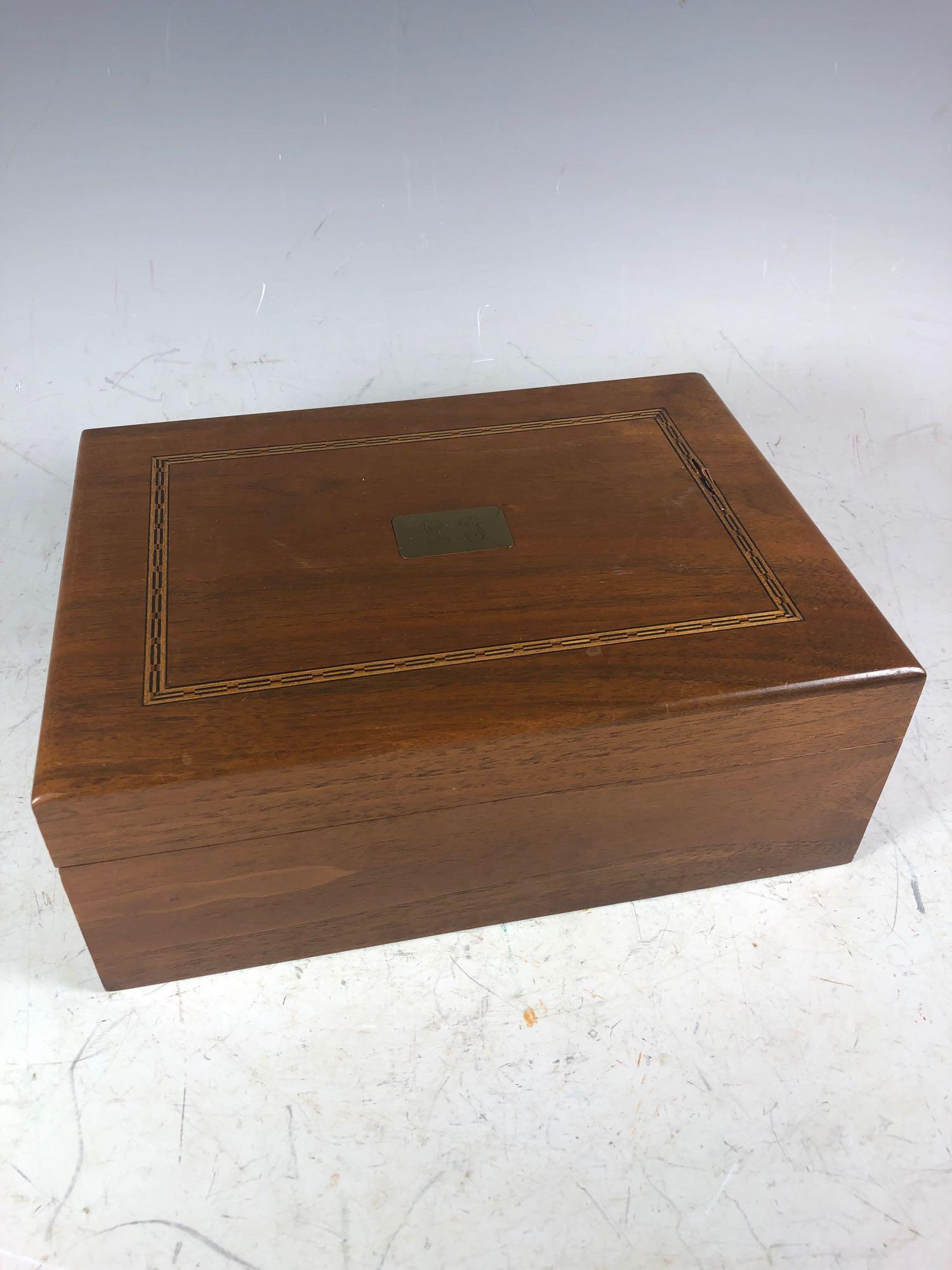 Gentleman's Mahogany Cigar Humidor: Lidded and hinged mahogany humidor box with inlaid top and brass monogrammed center.Â 20th century humidor filled with various central American cigars.Â Measuring approx 11" log x 8" deep x 4.5"