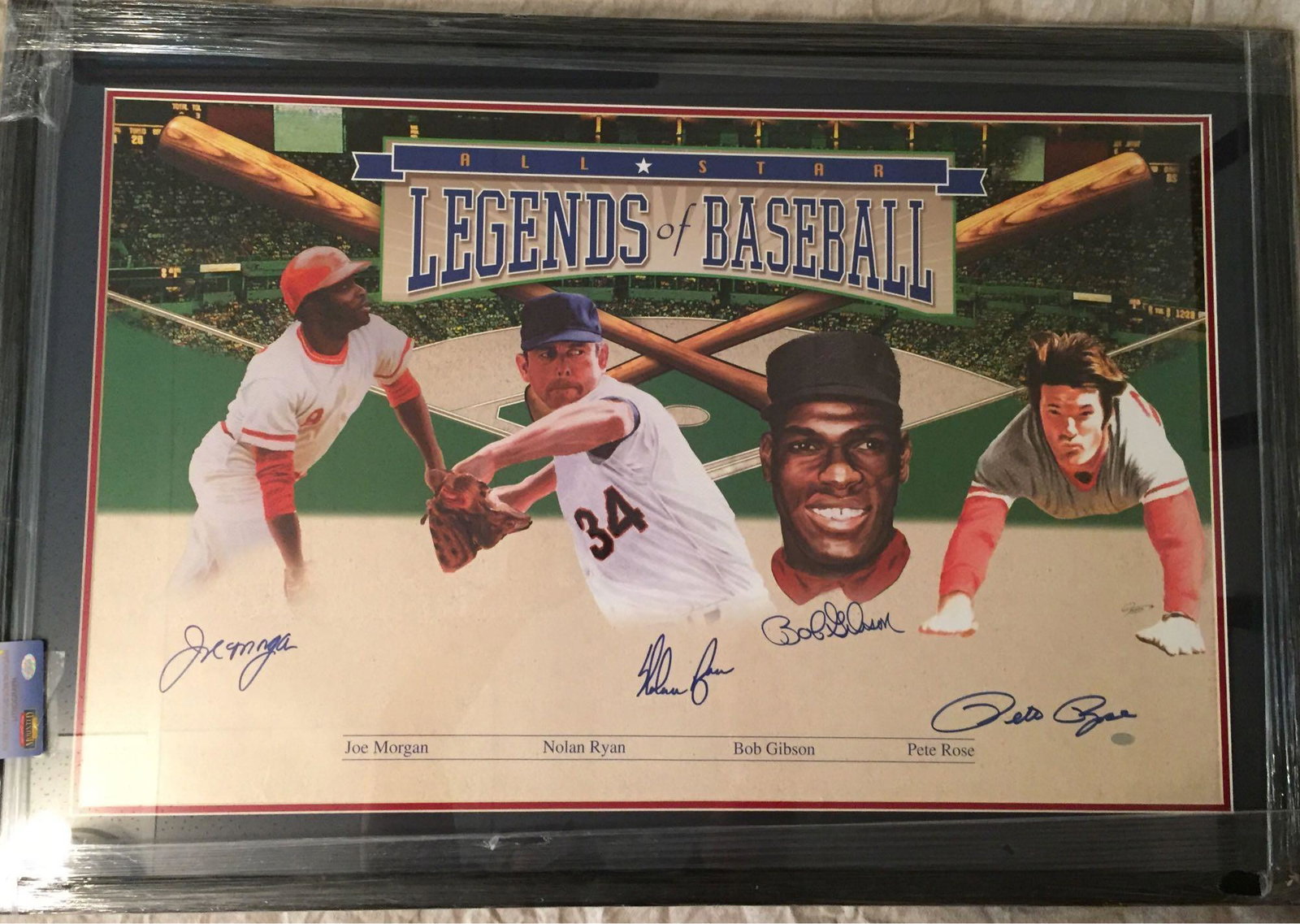 Legends of Baseball Autographed Litho Rose, Ryan,: Approx. 40x28 framed and matted poster features Pete Rose, Bob Gibson, Nolan Ryan and Joe Morgan. Blue marker signatures by all. Mounted Memories hologram and cert card. Comes with an Auction House LO