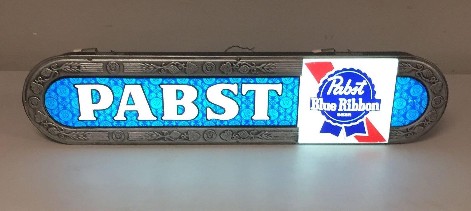 Pabst Blue Ribbon Lighted Beer Sign: Approx 36" long sign that light up wonderfully. Great color! There are some very minor signs of use. Takes a few seconds to turn on, otherwise works great.