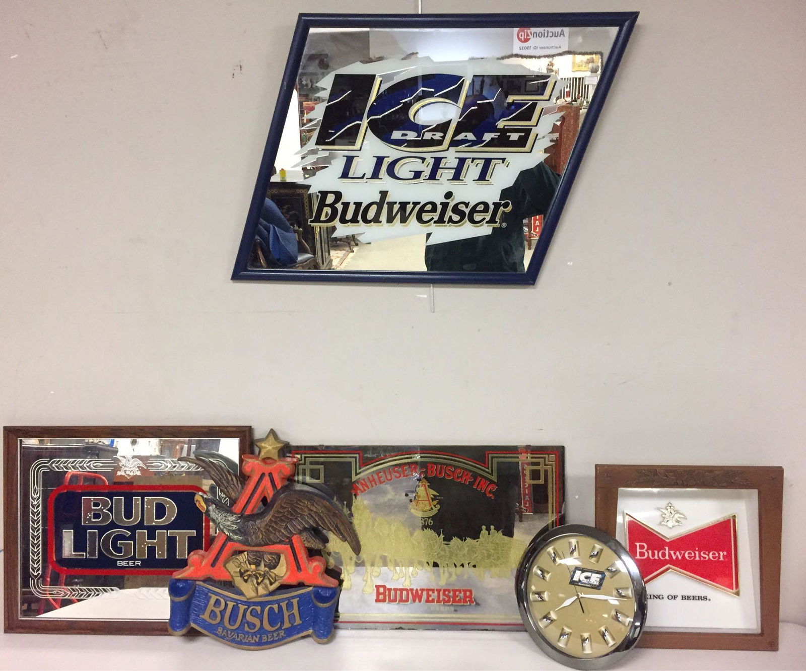 Budweiser Products Advertising Lot: (6) pieces from the Bud family; Budweiser ICE draft light mirror/sign, Same logo in a unique clock, BUD LIGHT logo mirror/sign, Anheuser Busch Bavarian Beer hanging logo, Budweiser mirror/sign with th