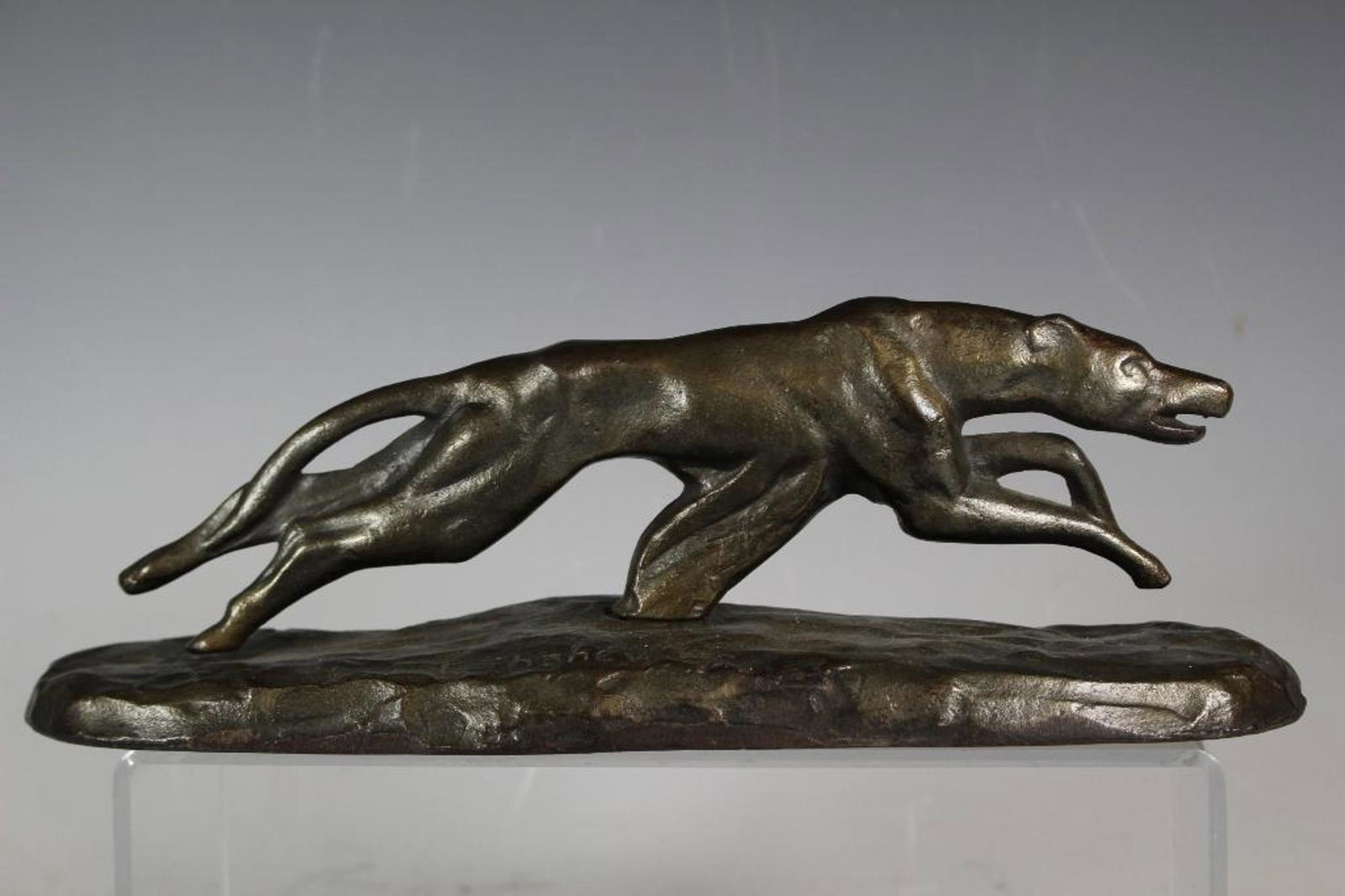 Art Deco Greyhound Sculpture, c. 1930: Art Deco sculpture/doorstop of a running Greyhound dog. It measures 12" long by 3 1/4" wide and it stands 4" high. There is an artist signature: F. Chahey and the date of 1929. The sculpture is made o