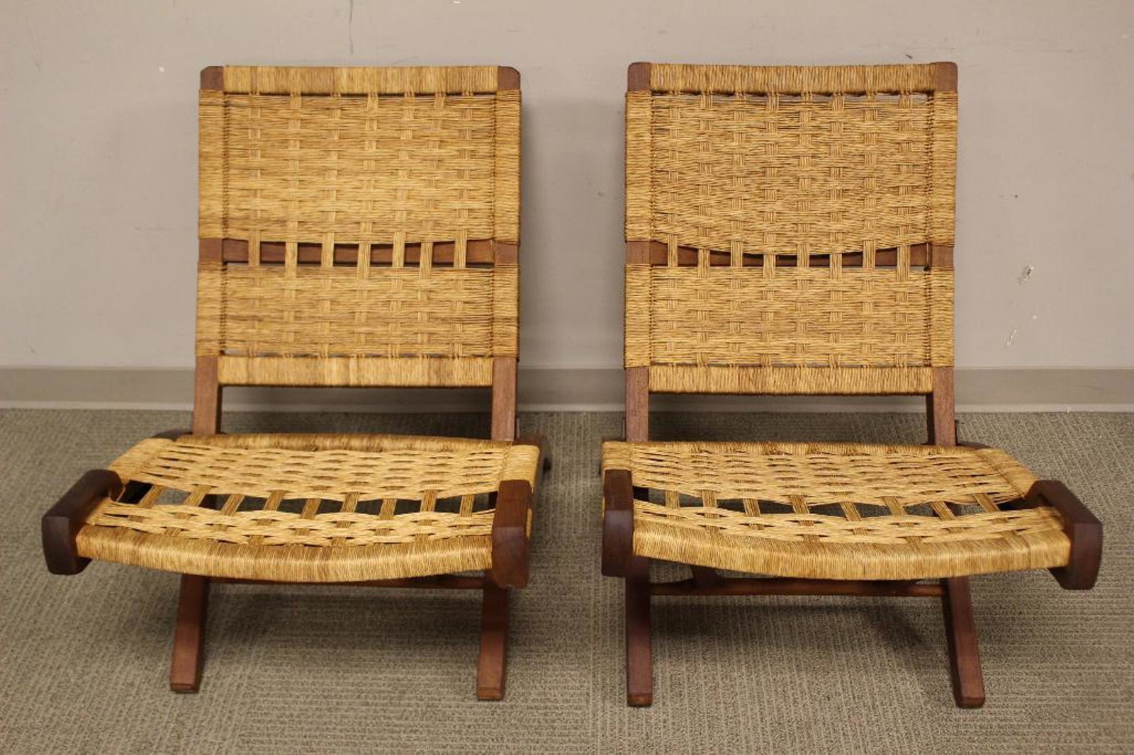 Pair of Hans J. Wegner Style Folding Chairs: Pair of wood folding chairs attributed to Hans J. Wegner. Hans JÂ¿rgensen Wegner was a world-renowned iconic Danish furniture designer. His high quality and thoughtful work, along with a concerted e
