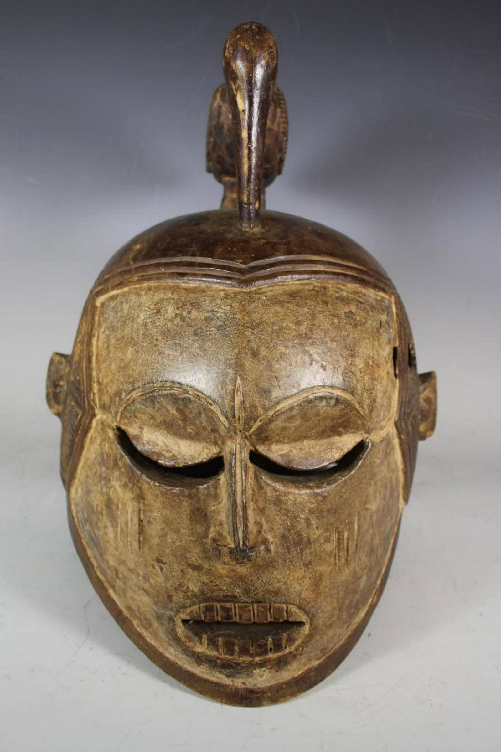 Carved African Helmet Dress Mask With Bird: 20th century carved African helmet mask Subu tribe from Zaine region. Measuring approx 17" tallx 19" deep x 14" wide.ÃŠ Normal use and wear as shown, see photos. The Isubu (Isuwu, Bimbians) are an e