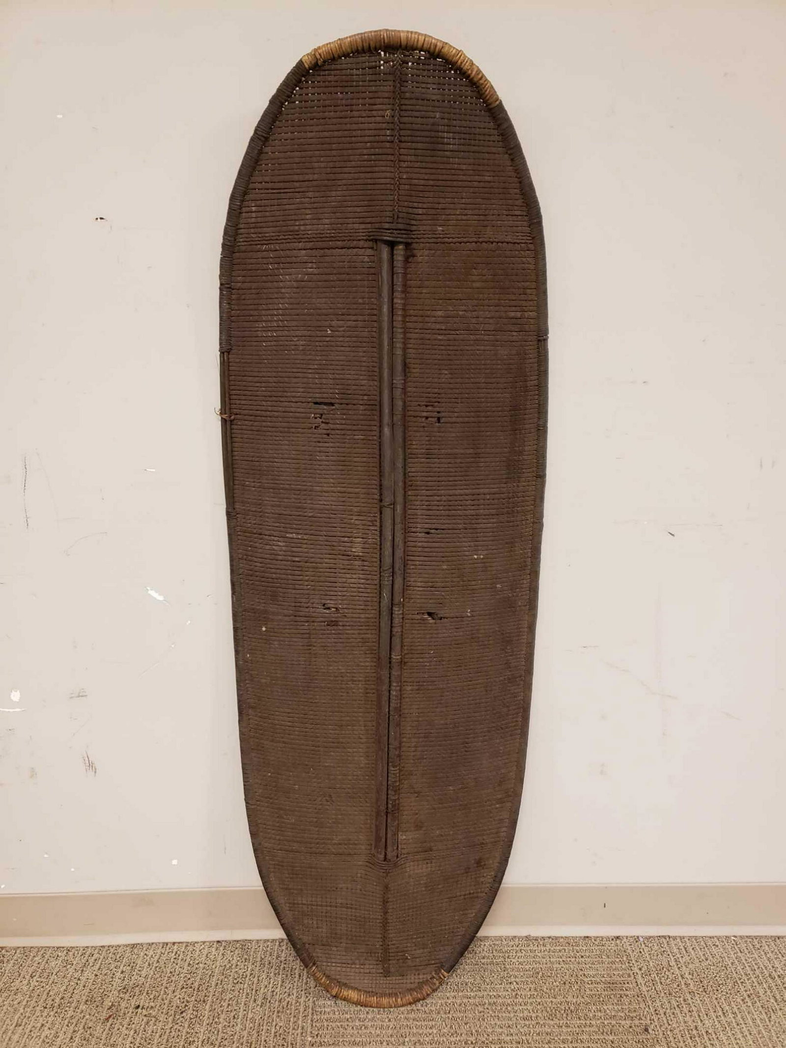 Woven African Tribal Shield: 20th century African tribal ceremonial shield with wood handle.ÃŠ Measuring approx 54" tall x 18".ÃŠ Normal signs of use and wear as shown, see photos.