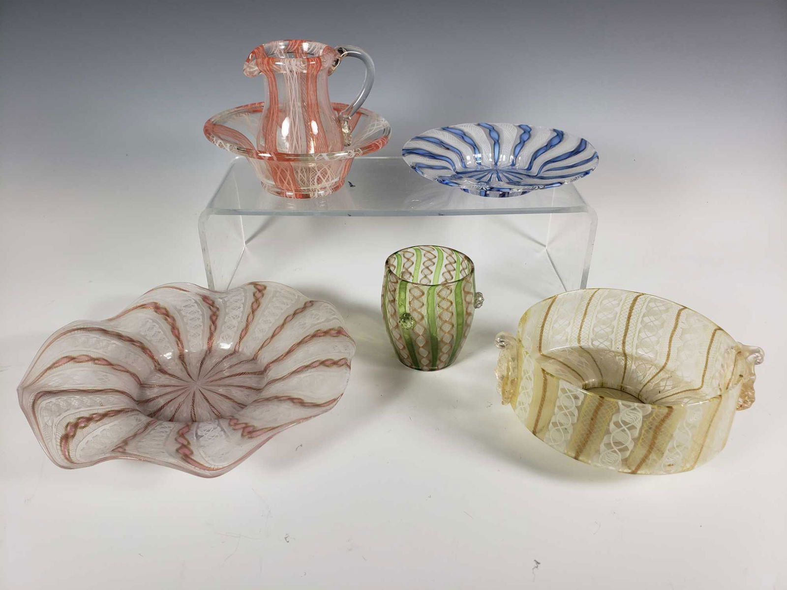 Victorian Venetian Art Glass Group: Fine 19th Century Italian art glass group. Venetian art glass includes yellow applied hand bowl, small creamer, green swirl with gold fleck vase or toothpick holder and several other dishes. All in go