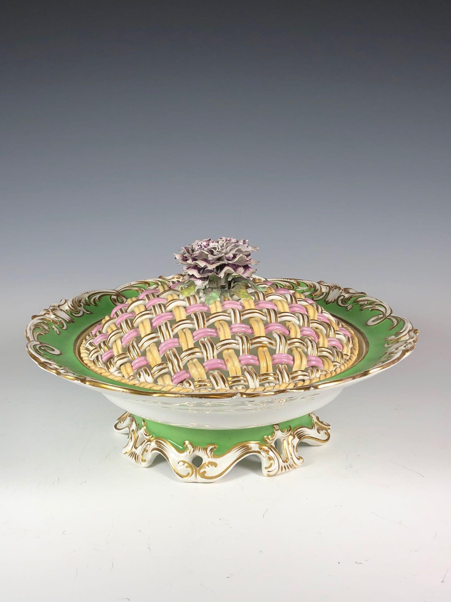 19th Century English Lidded Vegetable Bowl: Footed bowl/tureen with lattice woven lid. Measuring 5" tall by 10" wide. Condition few minor flaws to floral and light wear throughout.