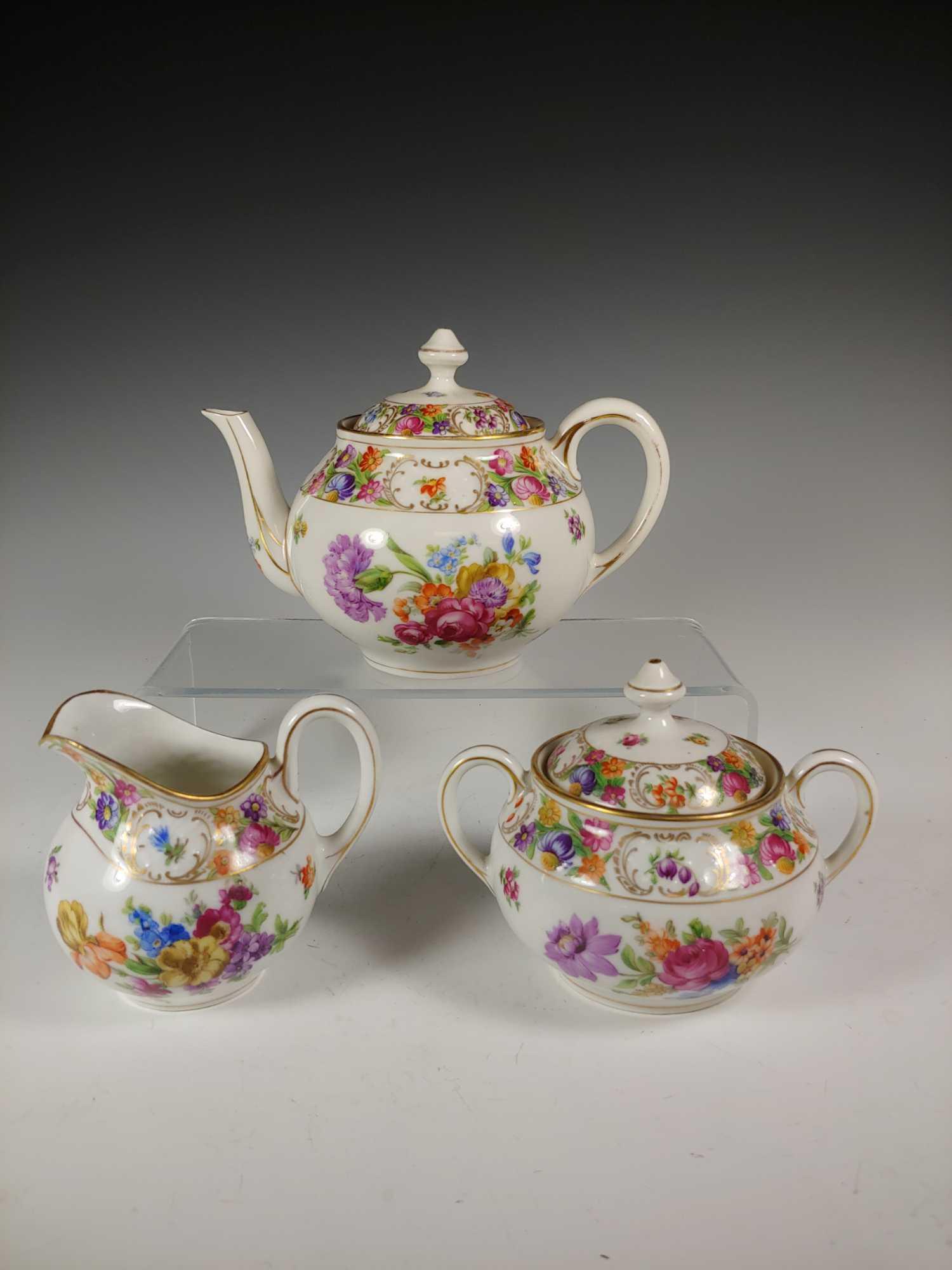 Dresden Flower Bavaria Teapot Creamer Sugar Set: Three piece Dresden Flower tea set. Includes 5 1/2" teapot with lid, sugar bowl with lid and creamer. Heavy bold colored floral decor with gold trimming throughout. In good condition with teapot havin