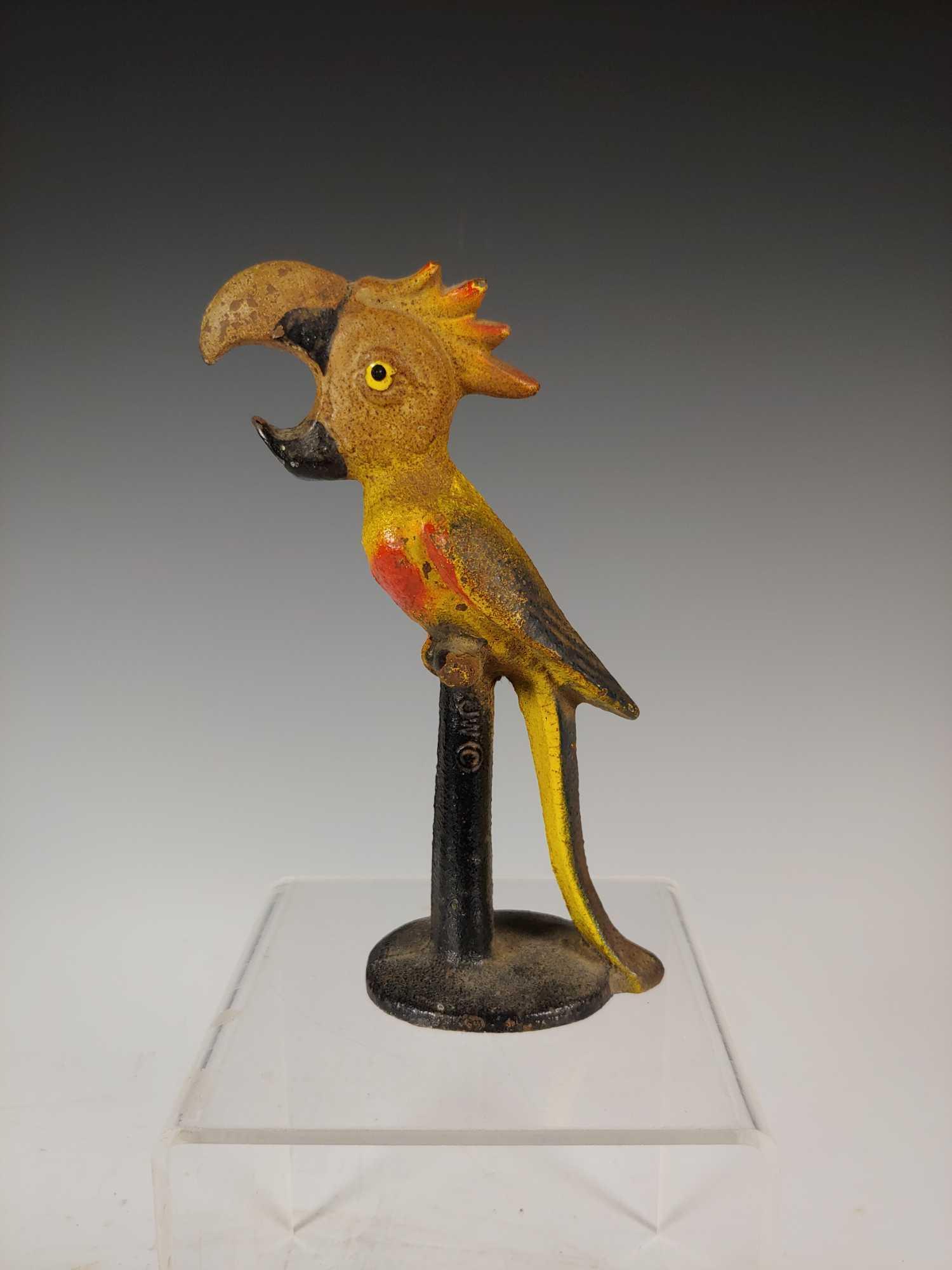 Antique Cast Iron Parrot Bottle Opener by John Wright: John Wright cast iron hand painted parrot bottle opener. Approx. 5 1/2" tall. In good age appropriate condition with some paint loss, see photos.
