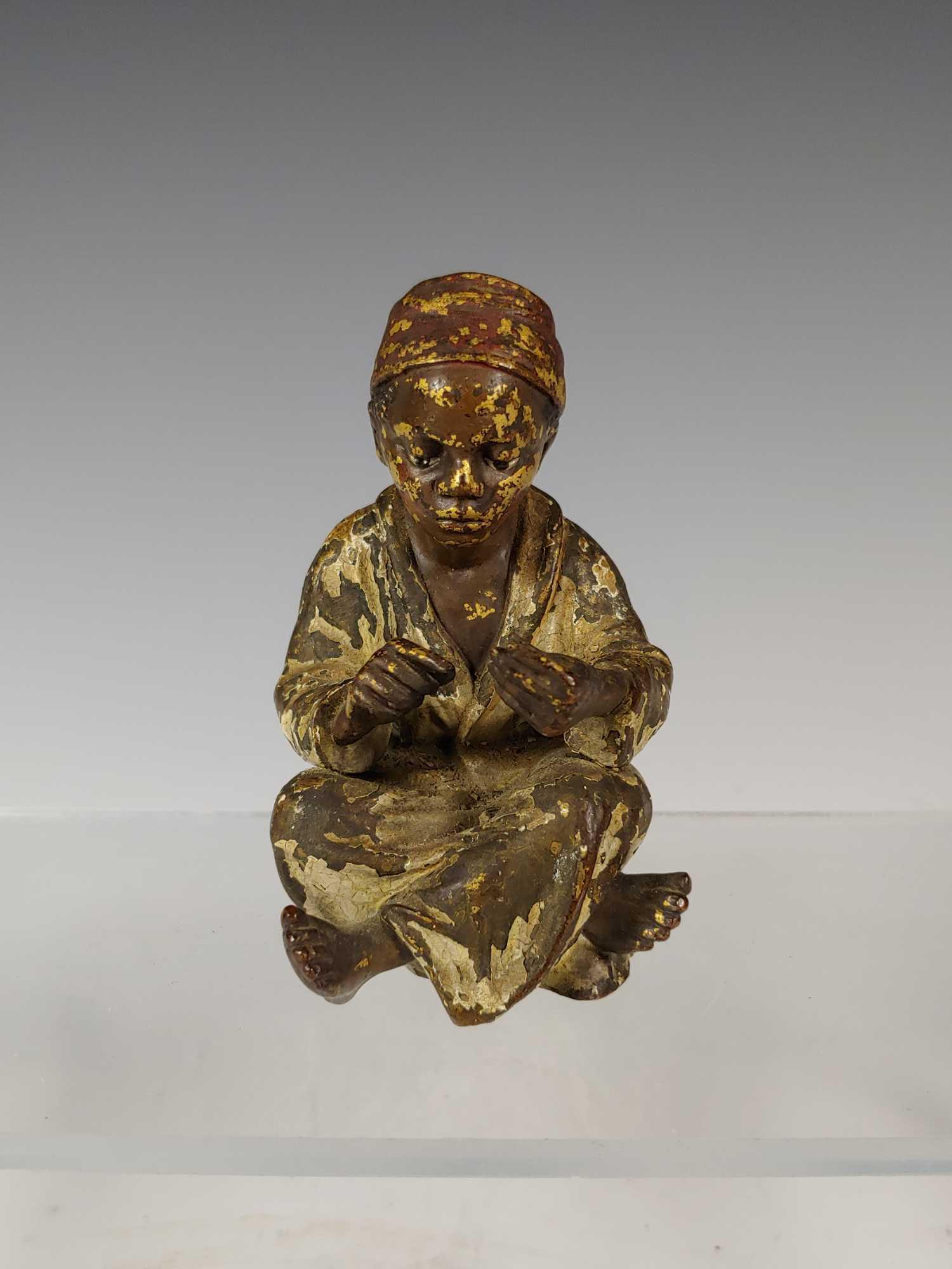 Franz Xavier Bergman {1861-1936) Bronze Arab Boy: Cold Painted Orientalist Bronze Sculpture fine early example of a signed F Bergmann. It depicts a seated Arab or North African youth. He sits with legs crossed on a floor that has low relief hieroglyp