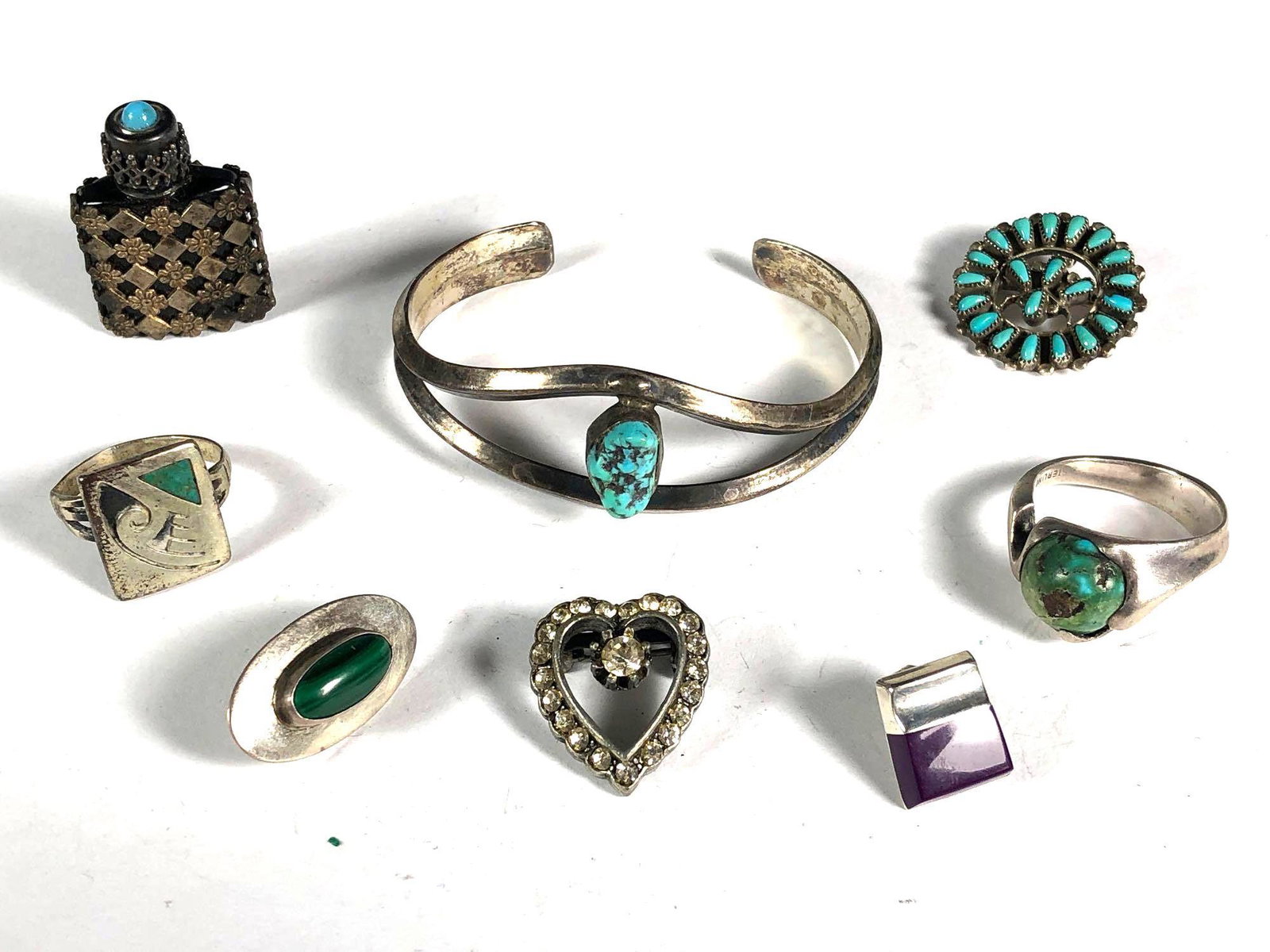 Vintage Mexican Sterling and Others: Includes Childs turquoise cuff, mens rings, single earrings, heart shaped rhinestone pin and others, see photos. Small sqaure ring has dents and damage. 39.1 grams total weight.