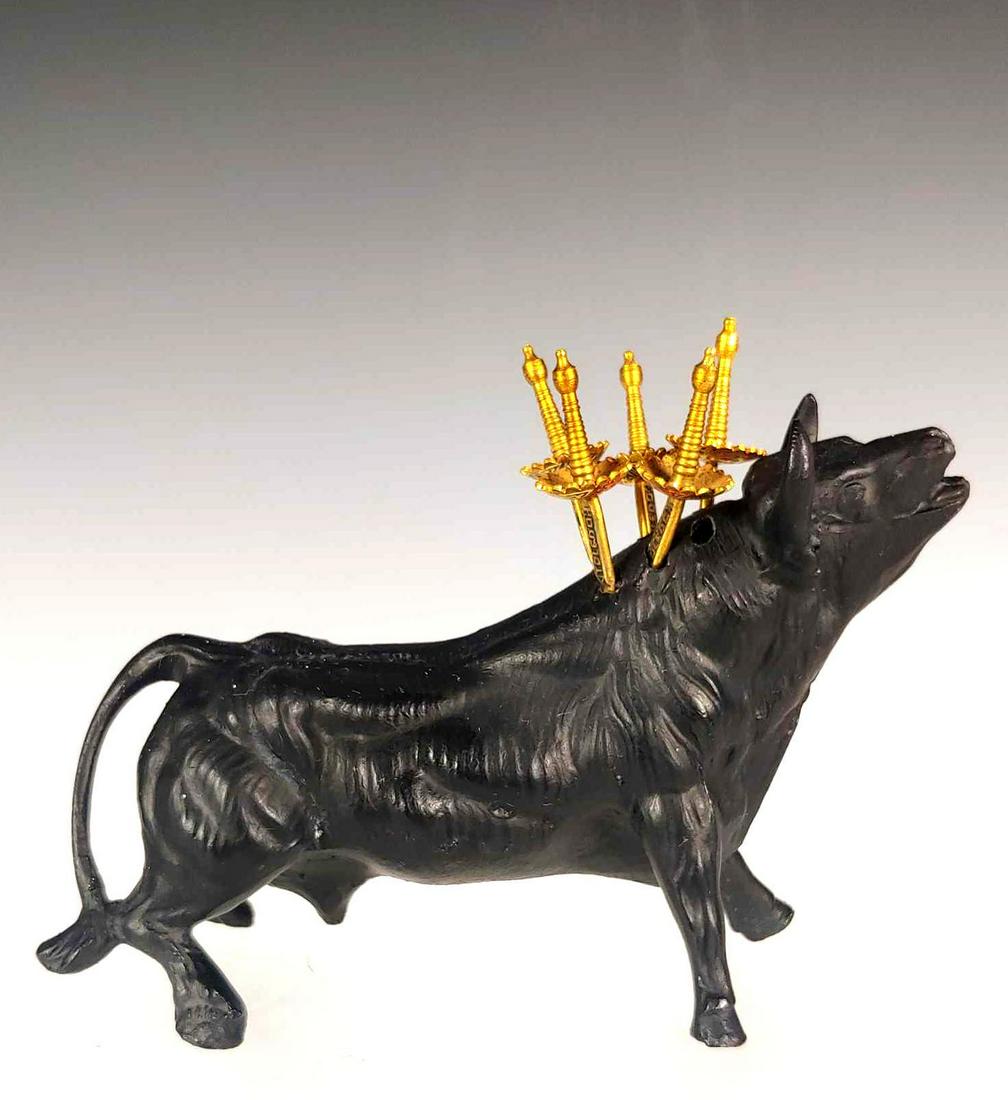 Vintage Spanish Toledo Sword Cocktail Server: Made of white metal by Toledo sword. Includes 6 toothpicks or cocktail spears seated in cast bull. Spanish influenced as shown. Measures 4 1/2" tall by 6" long and in good condition.