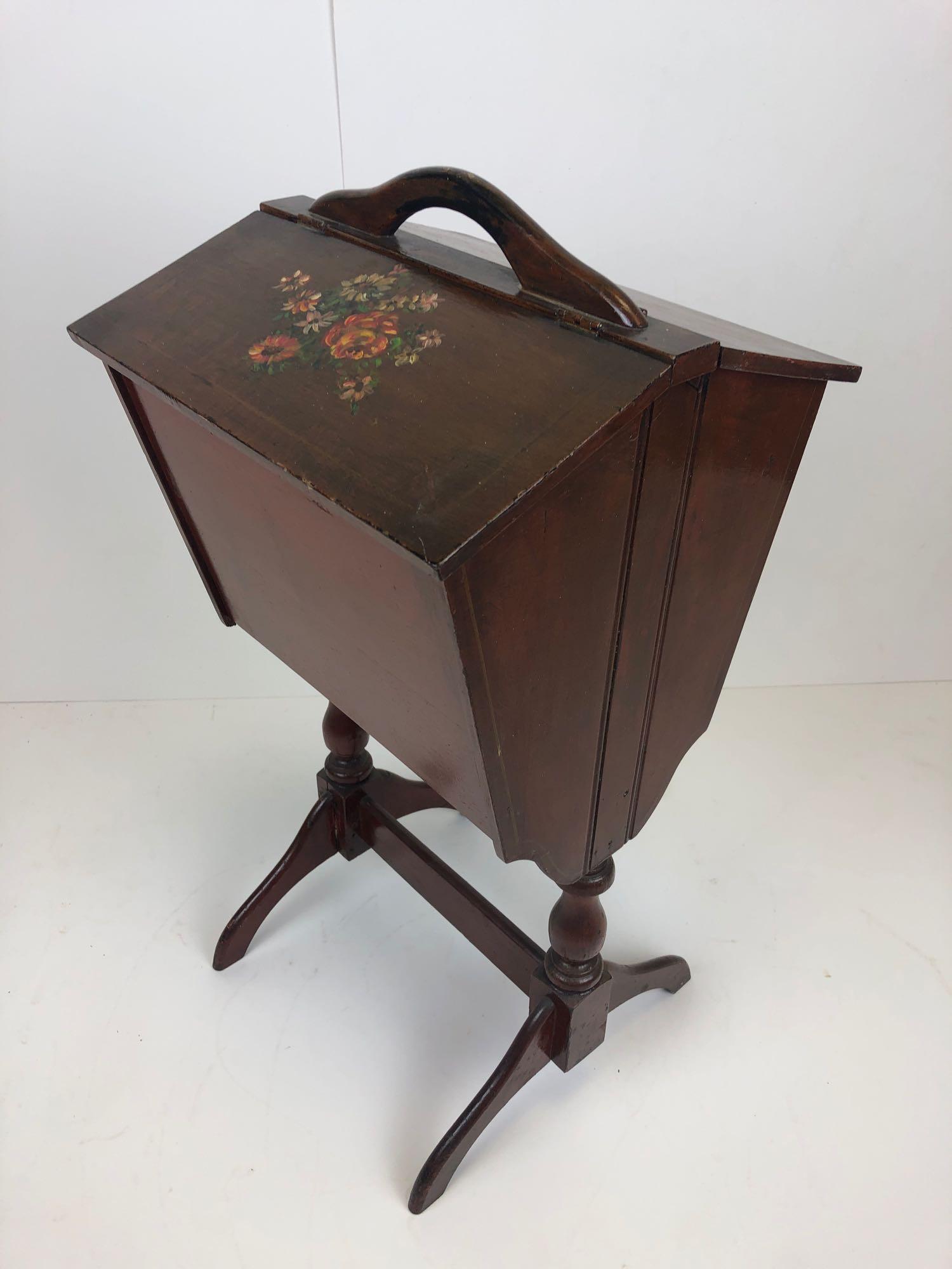 20 th C. Hand Painted Floral Primitive Wooden Sewing: 20 th C. Hand Painted Floral Primitive Wooden Sewing Caddy Cabinet. Good clean overall condition with wear to the feet- see photos. Has one sliding drawer inside for storage. Measures approximately 26