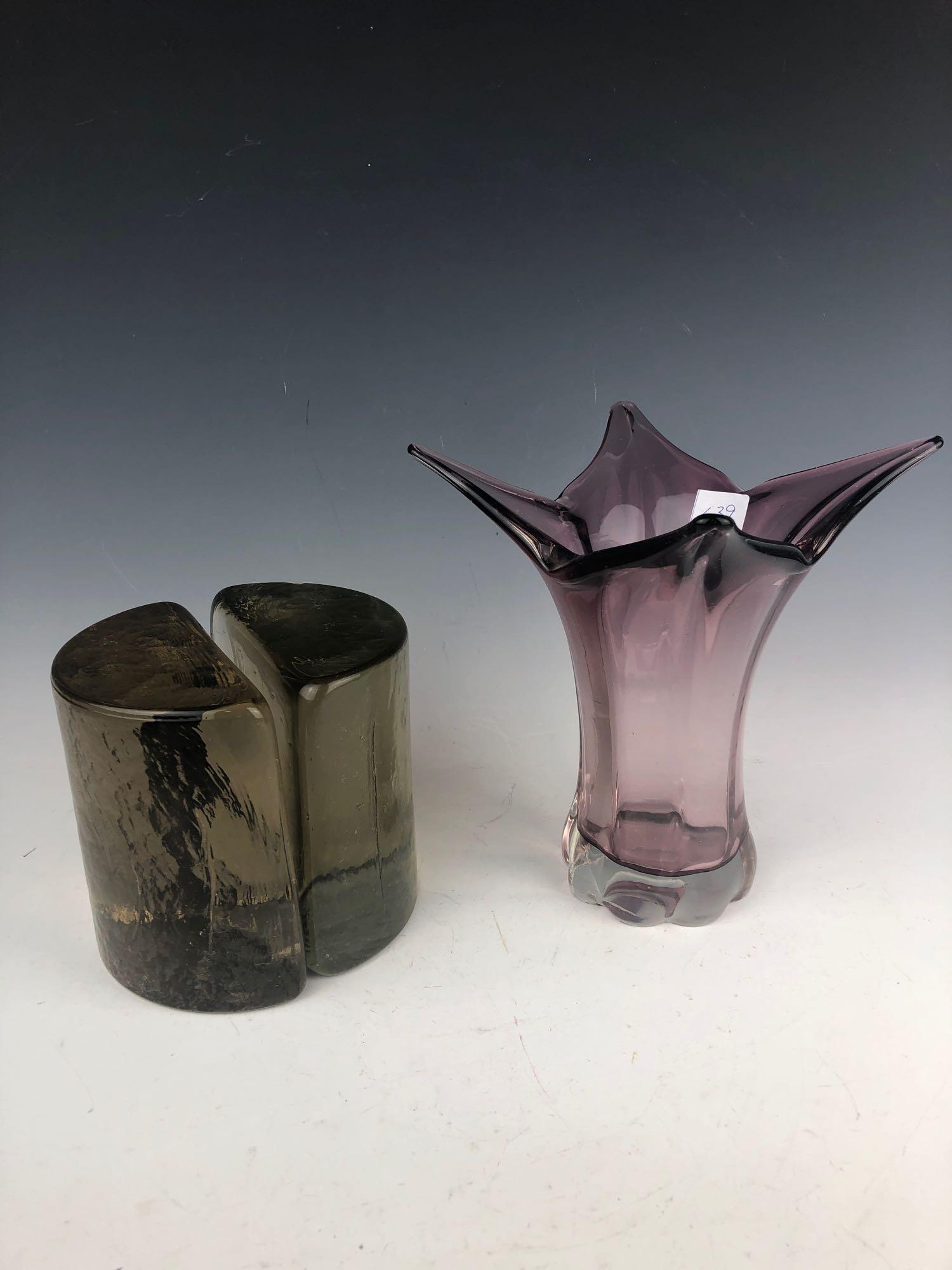 Mid Century Blenko Half Moon Brown Ice Bookends, and: Mid Century Blenko Half Moon Brown Ice Bookends, and Fluted Purple Vase Lot. The bookends have chips around edges, and vase does not have any chips or cracks. bookends measure 5" tall x4.75" wide x 2