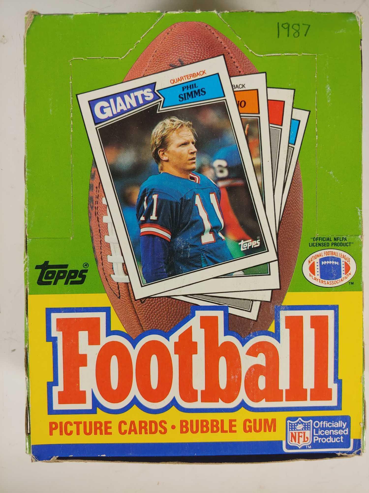 1987 Topps Football Card Wax pack Box: Unopened box of (36) packs that look to be fresh and tight in the box. Box does show signs of age. Many star and rookie cards such as Kelly, Cunningham, Haley, Herschel and others. Get grading!!!