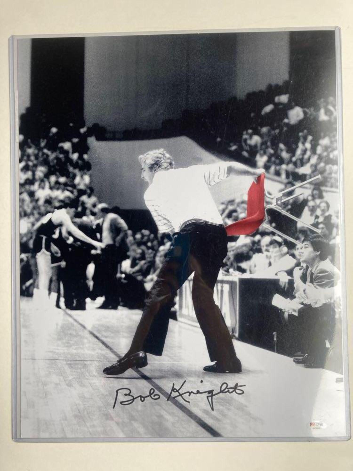 Bob Knight Autographed 16x20 Photo PSA/DNA: 16x20 photo of Bob throwing a chair. The photo is black and white except for the red chair. Very cool idea! Black marker signature by the coach. PSA/DNA sticker and cert.