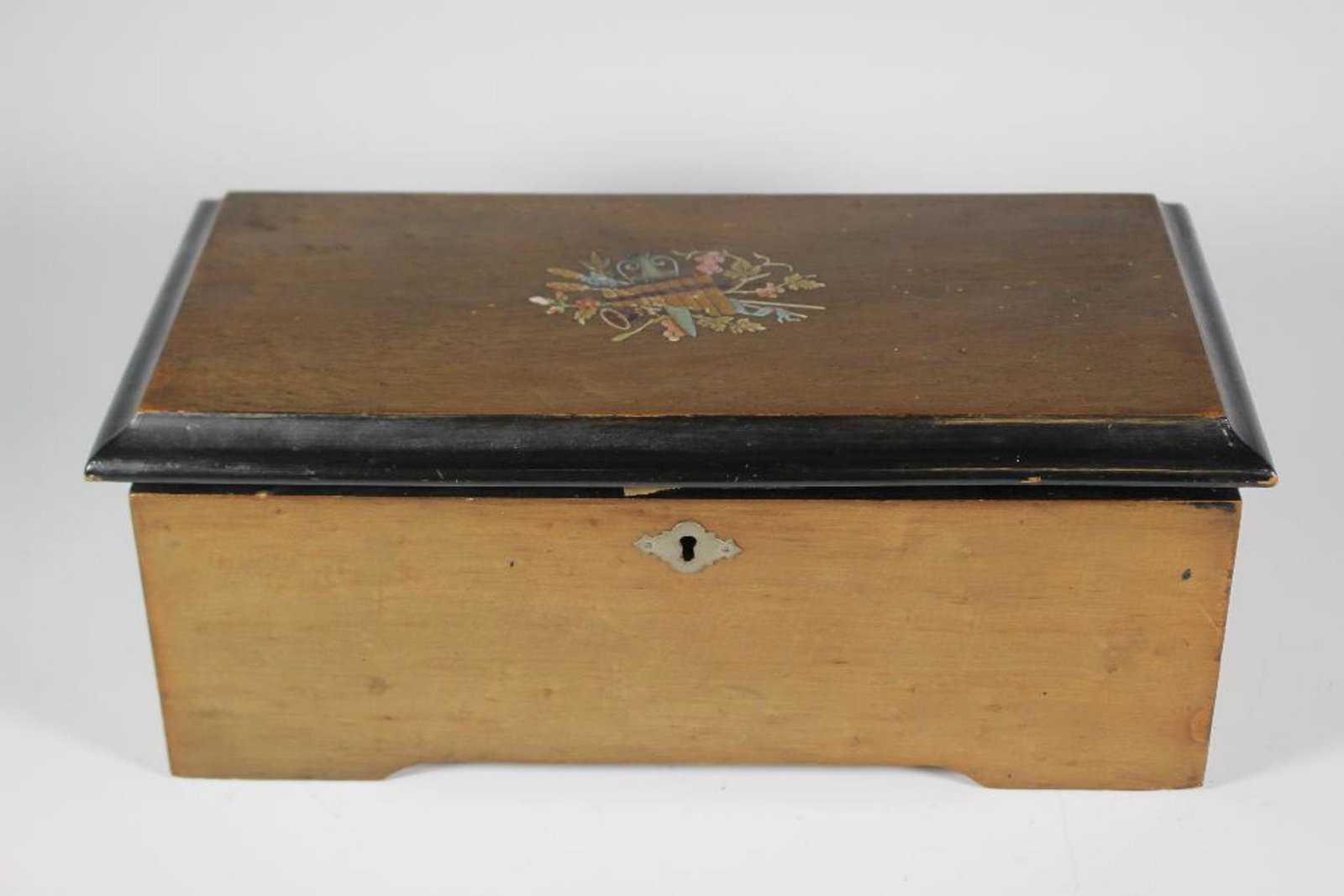 19th Century Swiss Cylinder Music Box: Swiss cylinder music box playing 8 various songs and in working condition. Lift top with paint decorated top and ebonized edge as shown. Late 19th century. Measuring approx 5.5" tall x 13" wide x 7" d