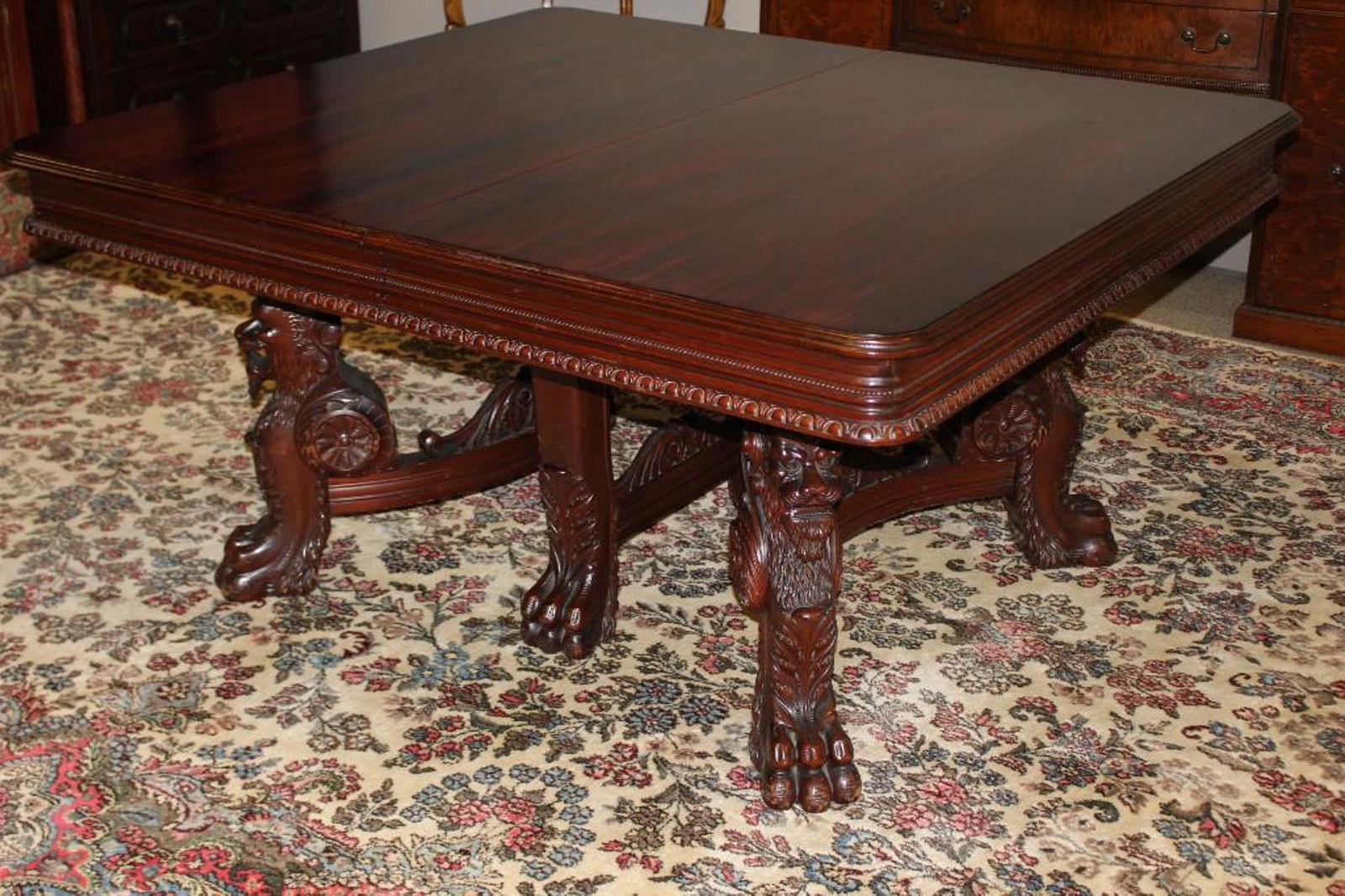Massive Mid 19th Century Heavily Carved Mahogany Table: Ca. 1850 carved claw foot and demon like lion legs. Carving and style of French carver Jacob Desmalter. Flamed mahogany top leading to 4 board apron edge having 2 pedestal and center support legs for
