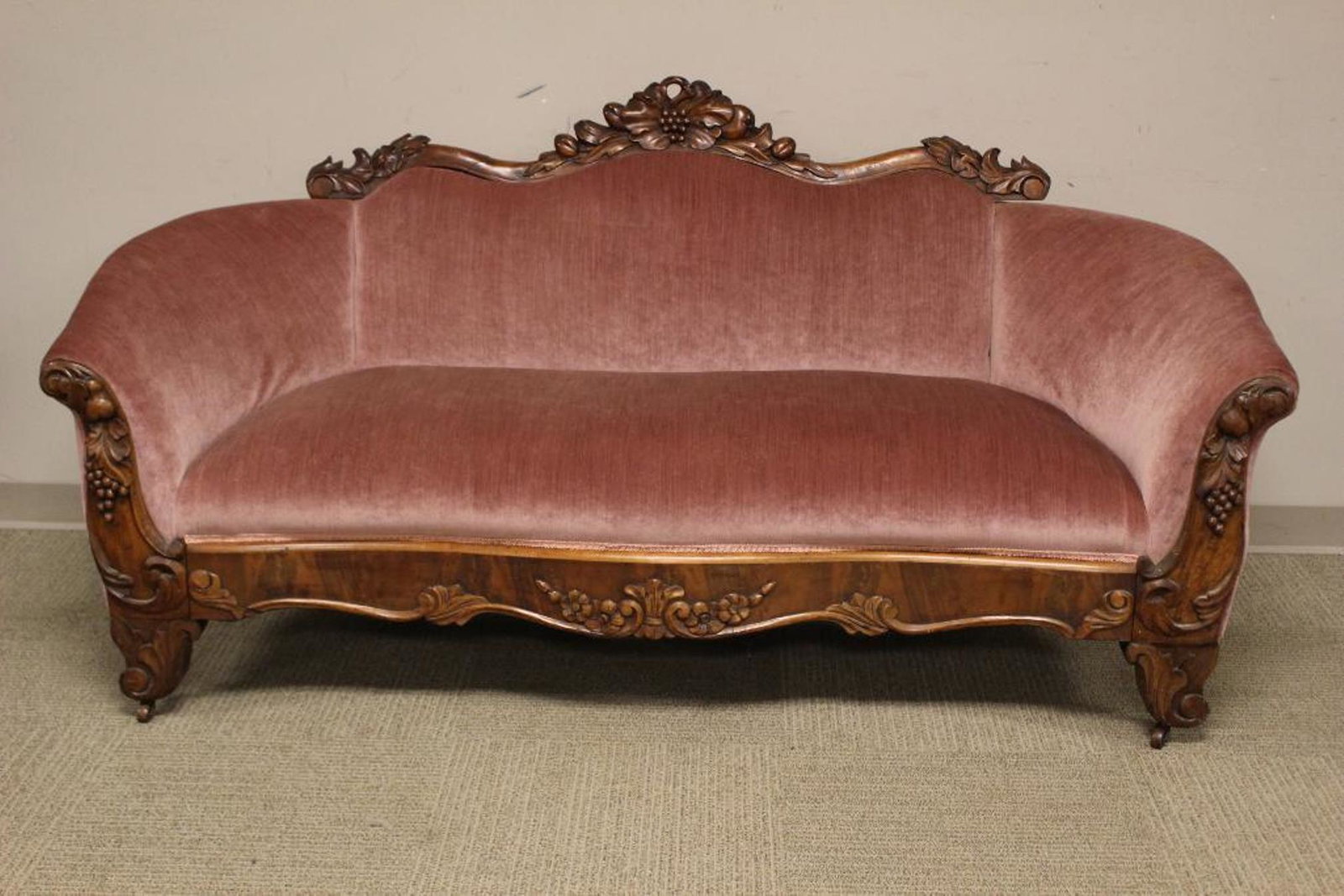Mid 19th Century Late Empire Rosewood Sofa: 19th century Empire Victorian transition period carved rosewood sofa in mauve upholstery. Measuring approx 75" wide x 36" tall x 27" deep. Normal use and wear consistent with age, see photos.