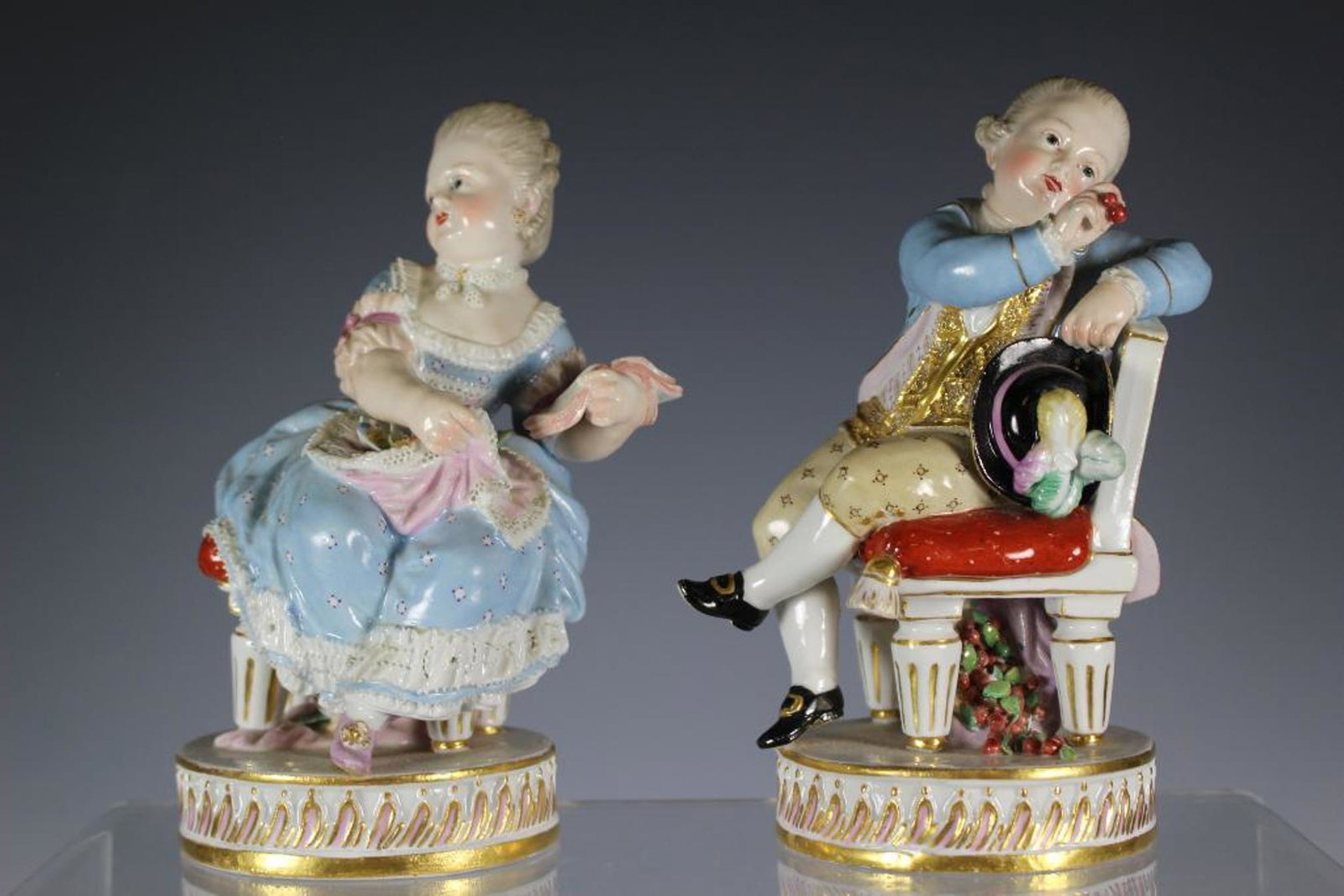 Pair of Meissen After M.V. Acier: Meissen porcelain figures, a pair of seated children, after the models by M.V.Acier, late 19th c., including: a young boy with painters impressions on verso 102 and signed impression as well as the se