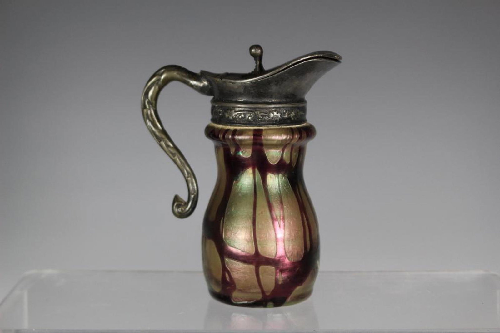 LOETZ Art Glass Syrup Jar: 19th century LOETZ art glass syrup pitcher having an ornate silverplate lid, height 4 1/2'' tall. Condition is very good as shown.