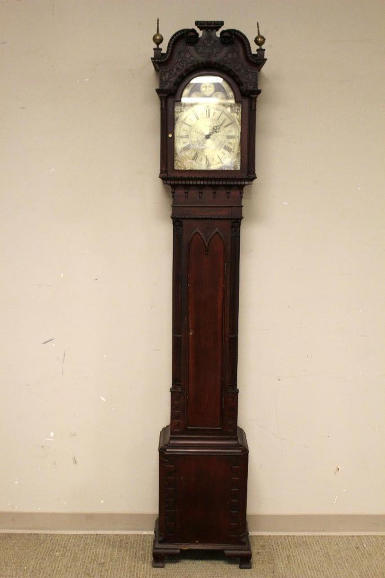 Carved Gothic Revival Tall Case Clock: Carved 19th century gothic style tall case grandfather clock. Mahogany, possibly Irish. Nice case needed work as face is not correct, finial lacking and not working. See photos. Measuring approx 7ft t
