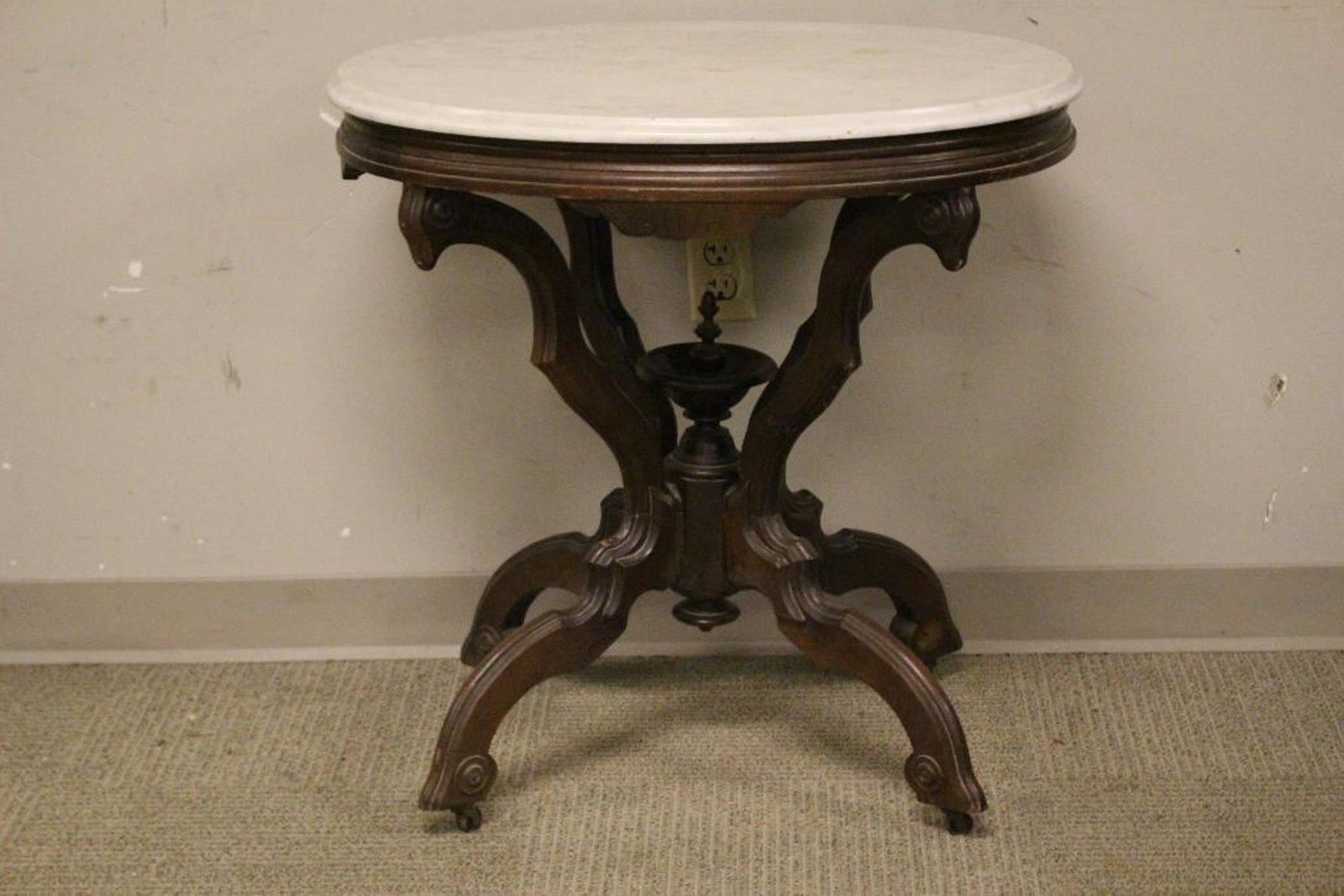 Carved Victorian Oval Marble Top Table: Carved 19th century black walnut Victorian marble top table. Measuring approx 28" tall x 29" wide x 21" deep. Condition consistent with age, see photos.