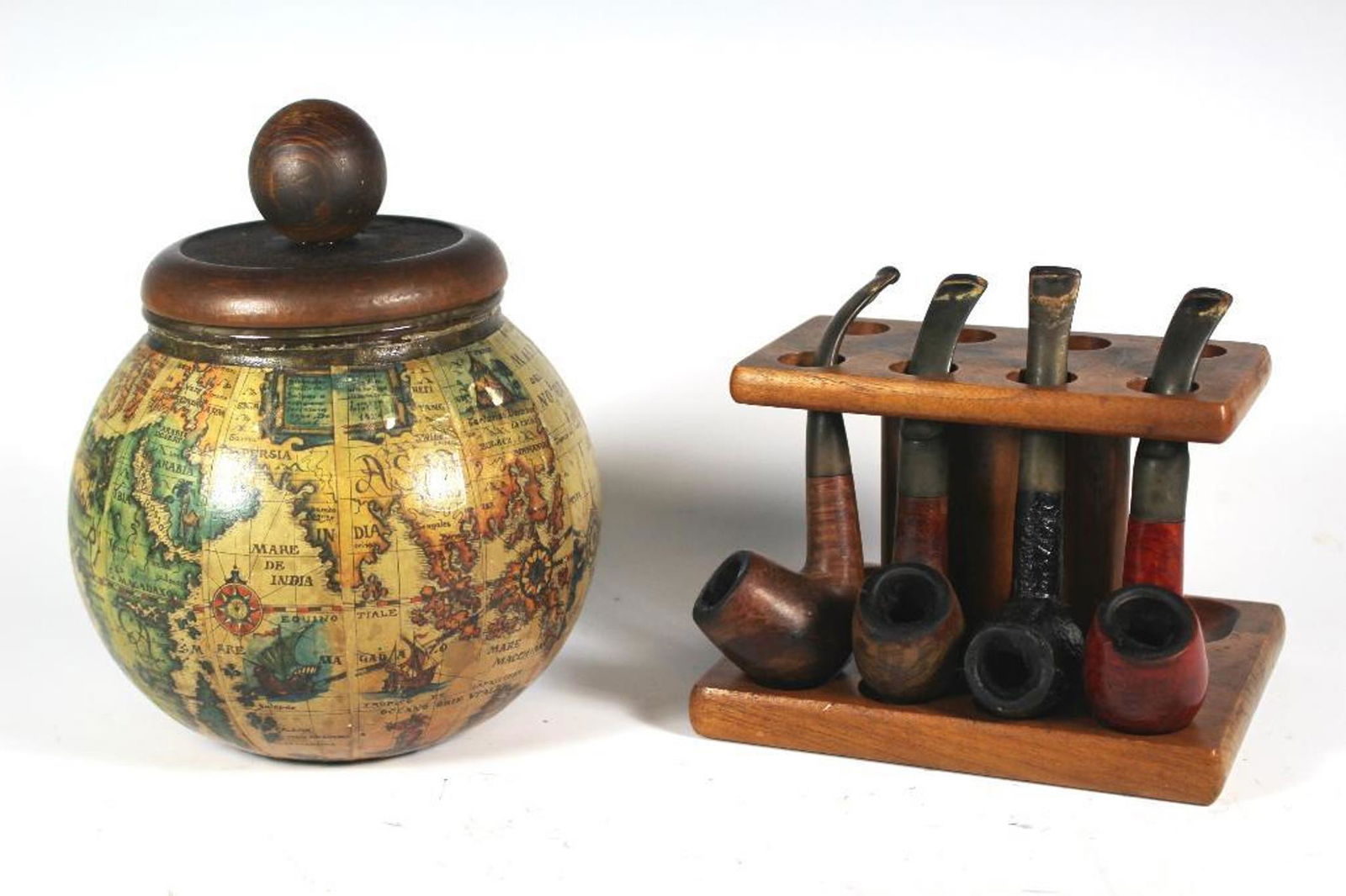 Tobacco Jar Stand and Pipes: Gentlemens collection of glass lined tobacco with map of old world and four pipes with stand. All in good vintage used condition, see photos.