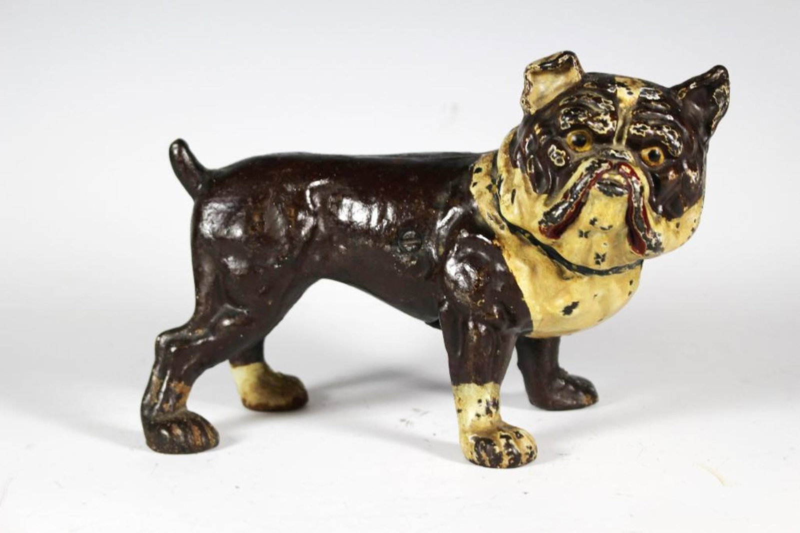 Hand Painted Cast Iron Bulldog Door Stop: Early cast iron hand painted Bulldog door stop. Approx. 9" wide by 6" tall. In good age appropriate condition with some paint loss, see photos.