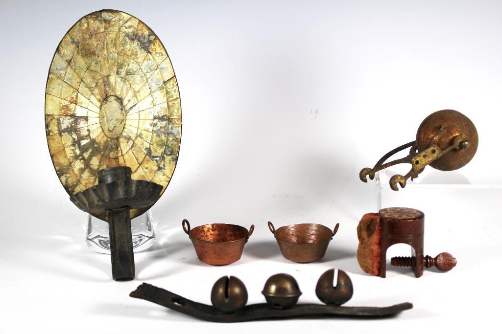 Primitive Collection Group Lot: primitive lot includes; 3 sleigh bells on leather, early brass hotel bell, attachable sewing table pin cushion, 2 small copper kettle pots 1 1/4" tall and early mirrored wall sconce approx. 10' tall w