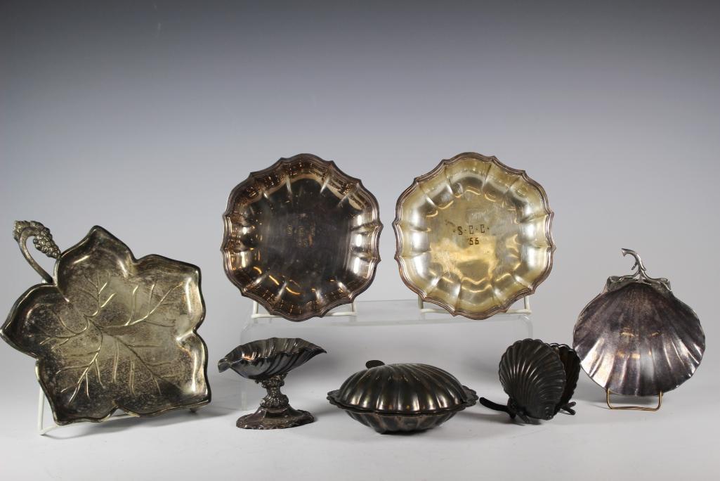 Large Group of Various Silver Plated Dishes: Including a seashell open with twig seaweed (.800 silver or lower), English shell soap dish (glass liner cracked), MMA footed shell dish, two 1955 trophy dishes, Oyster footed shell small compote and 
