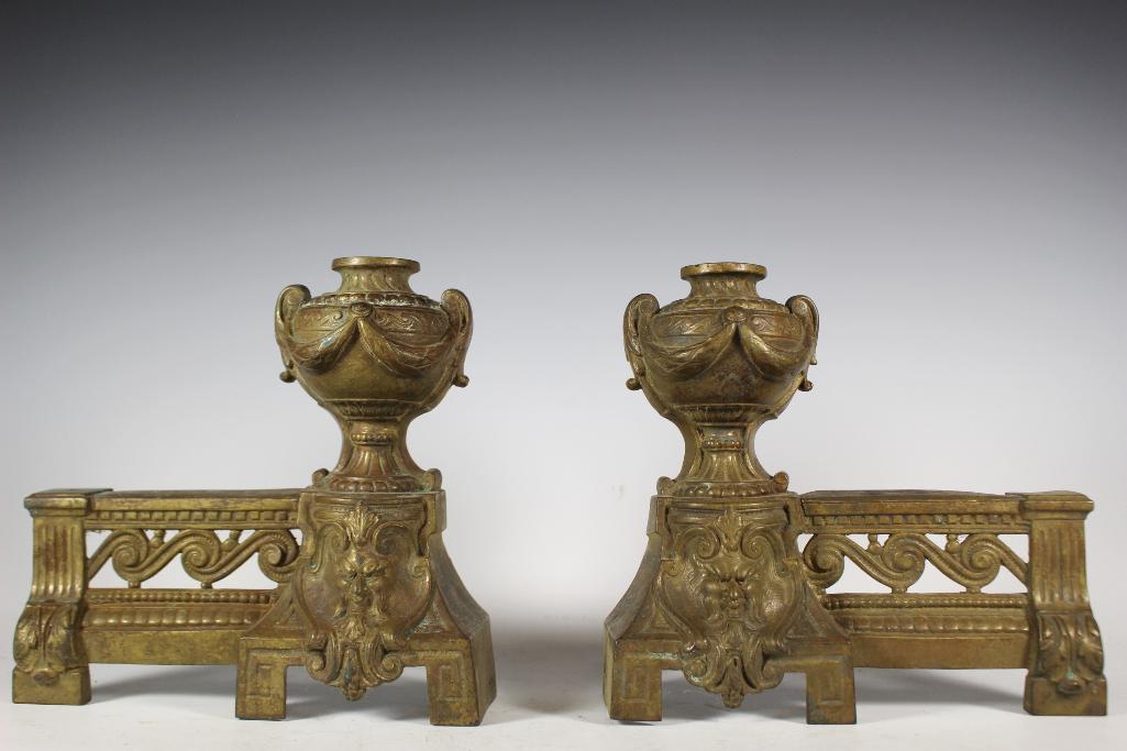 Antique Brass Demon Face Andirons: Late 19th early 20th century andirons depict demon faces at base below urns. Approx. 9" tall by 9 1/4" deep. In good age appropriate condition with signs of age, see photos.